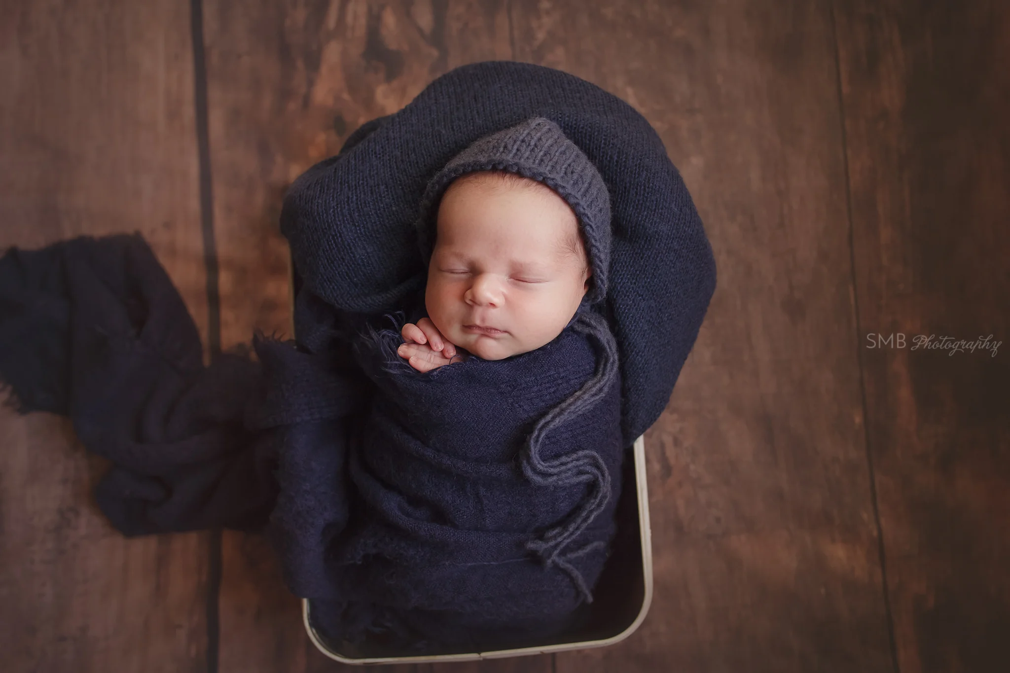 Newborn wrapped in navy blue