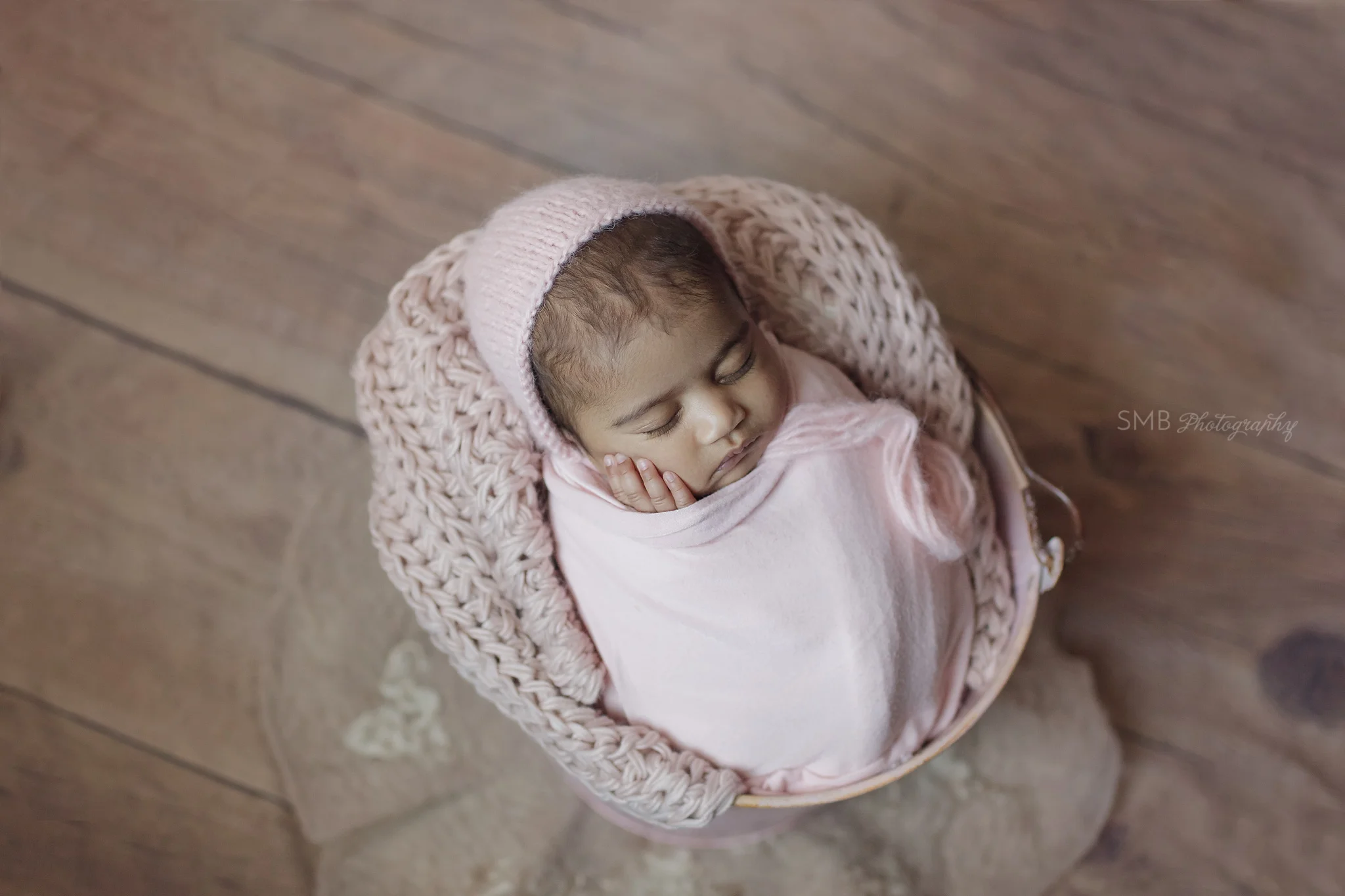 Baby girl wrapped inside a pink bucket