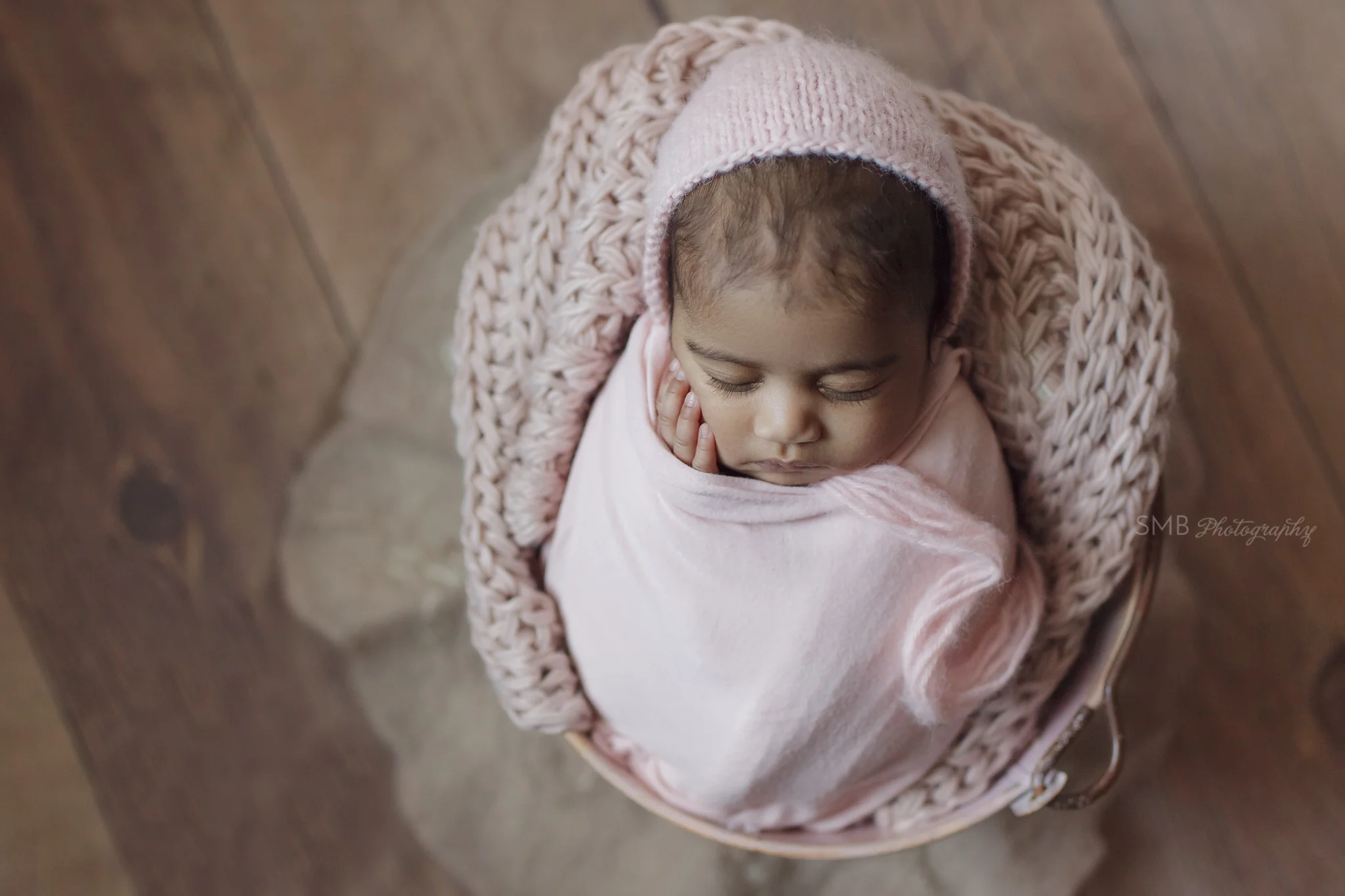 Baby girl wearing a pink bonnet