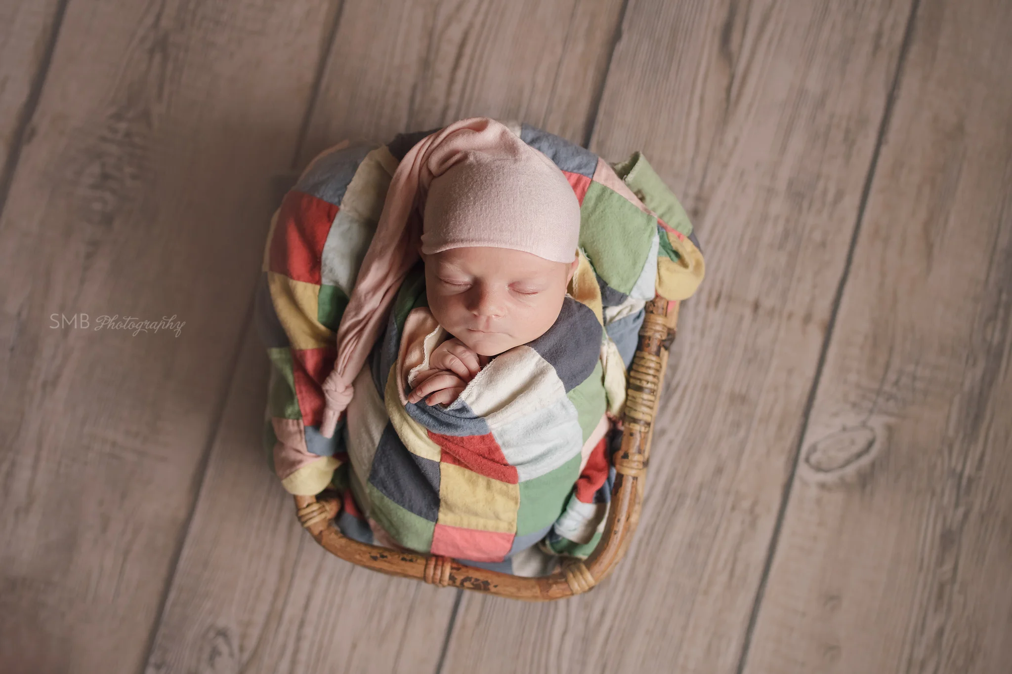 Newborn girl wearing pink sleep hat
