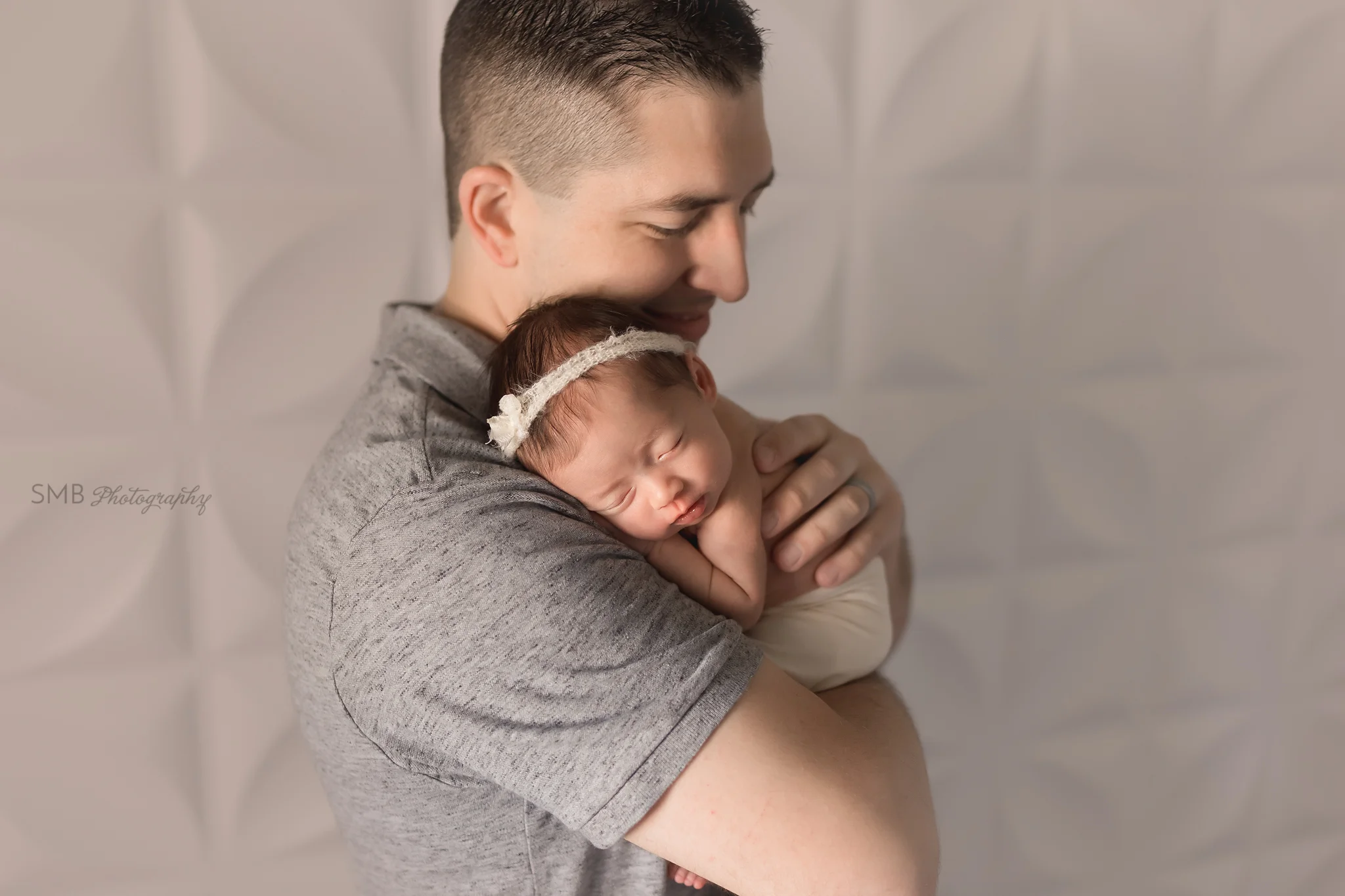 Dad holding newborn daughter