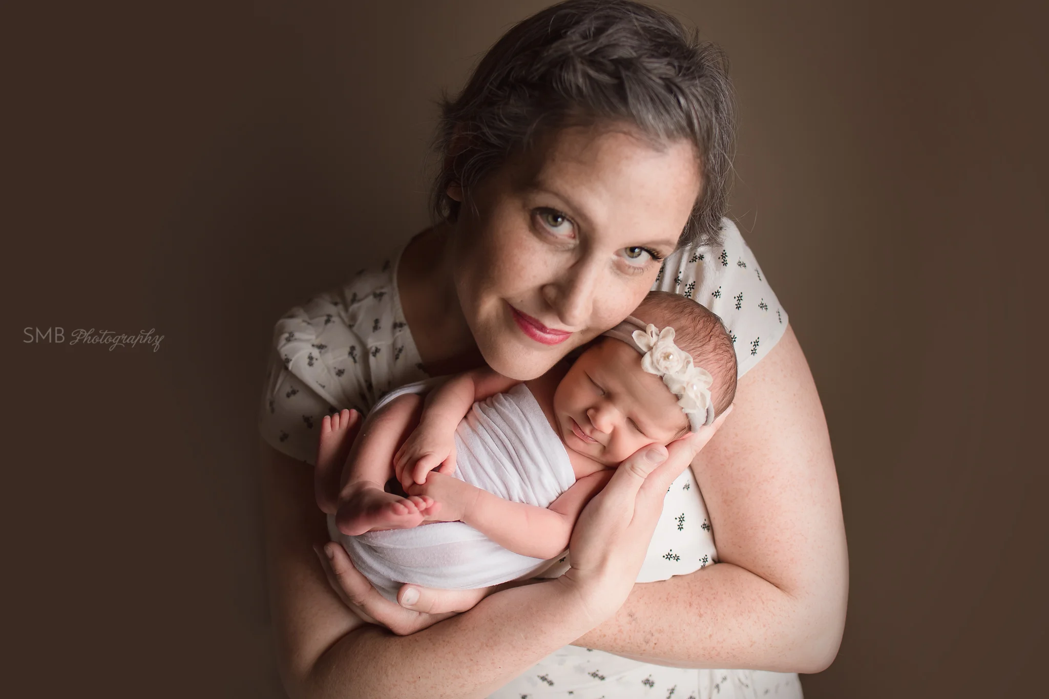 Mom holding newborn daughter