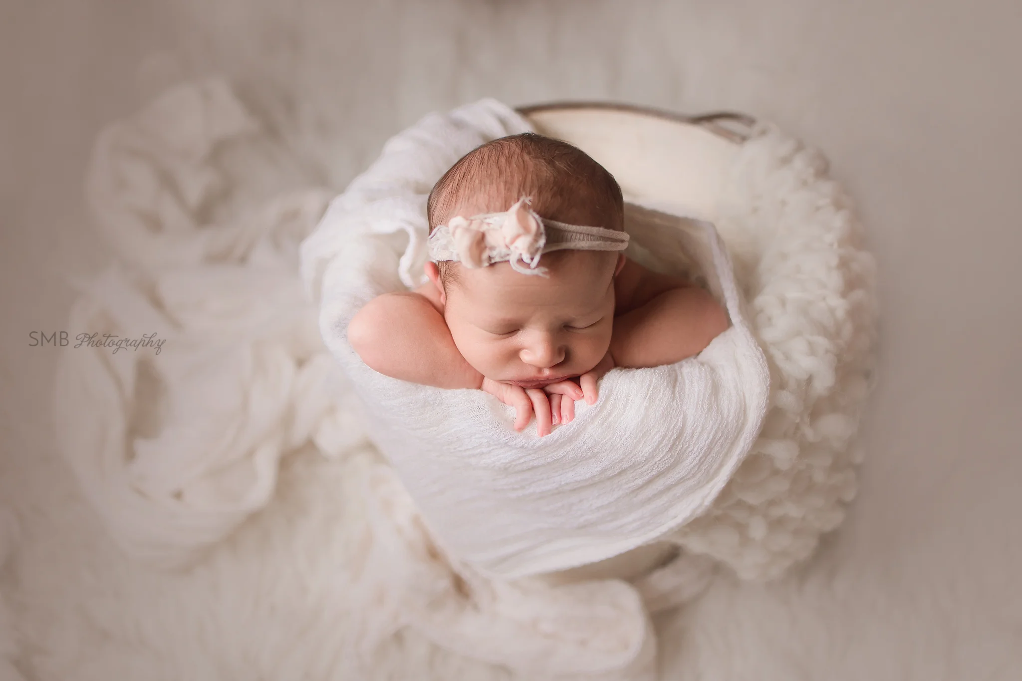 Baby girl in cream bucket