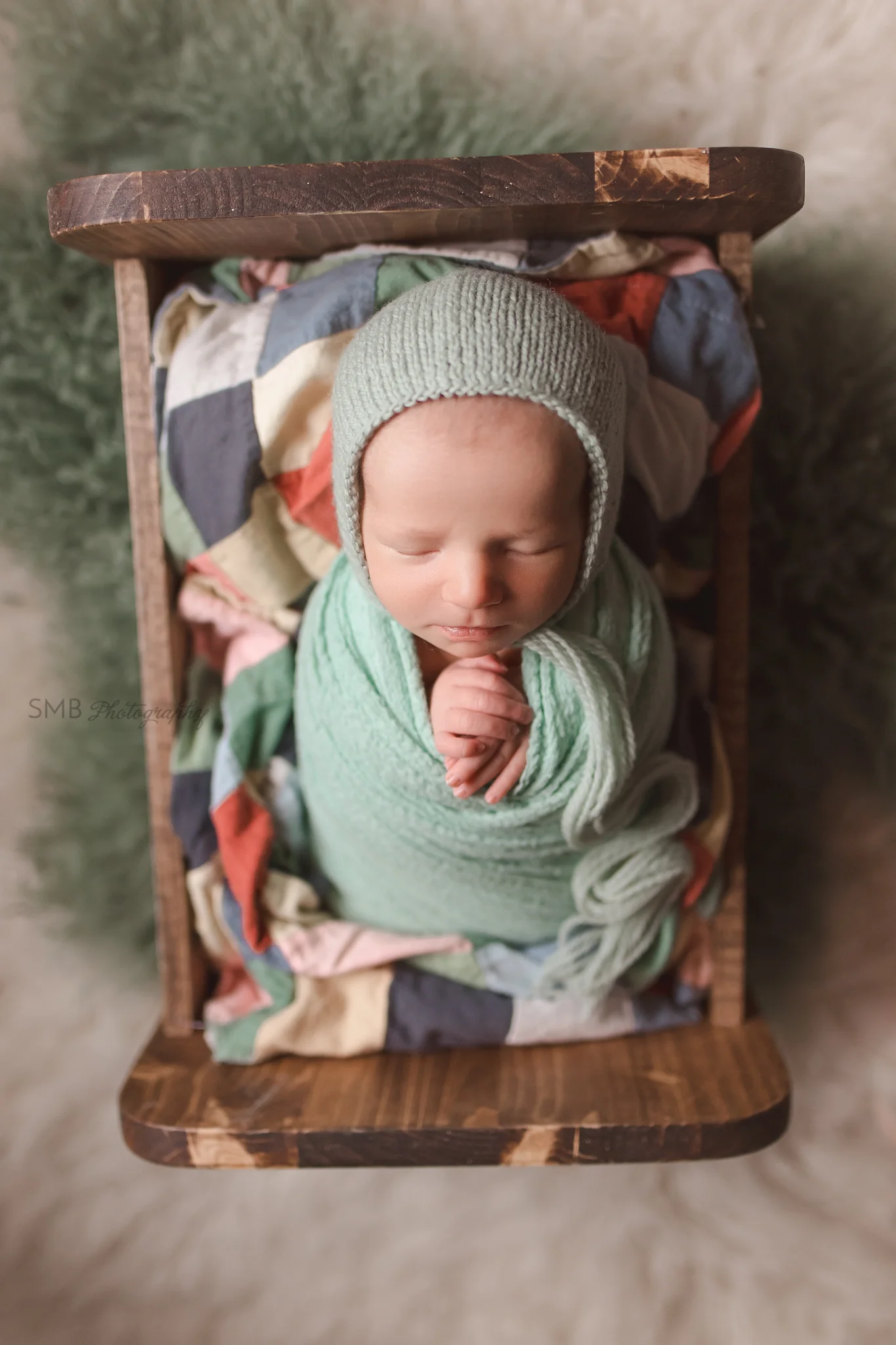 Newborn girl in baby bed wrapped