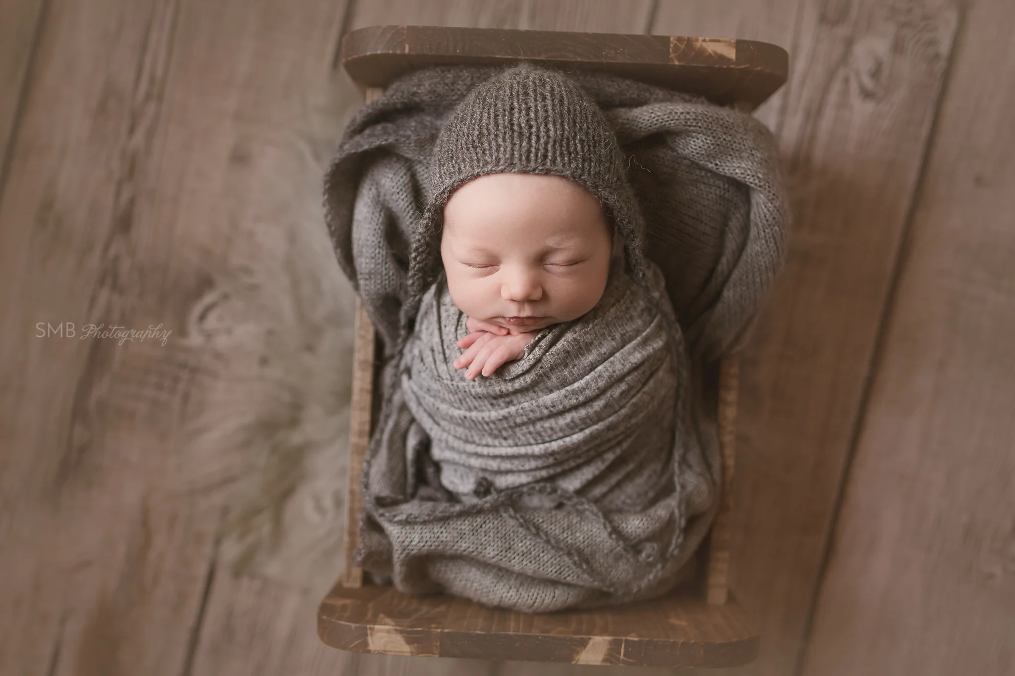 Newborn boy wrapped in baby bed