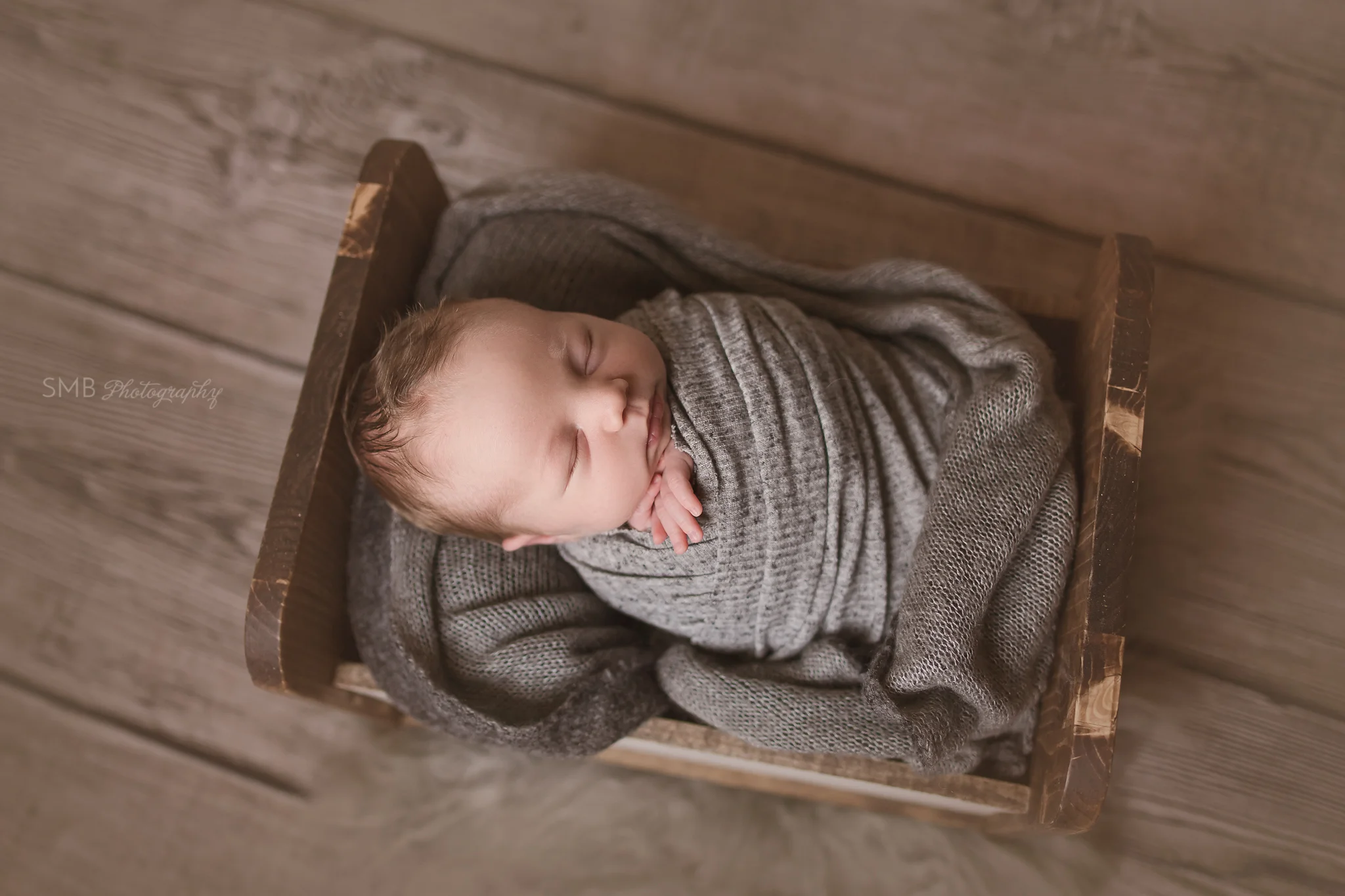 Baby boy wrapped in gray