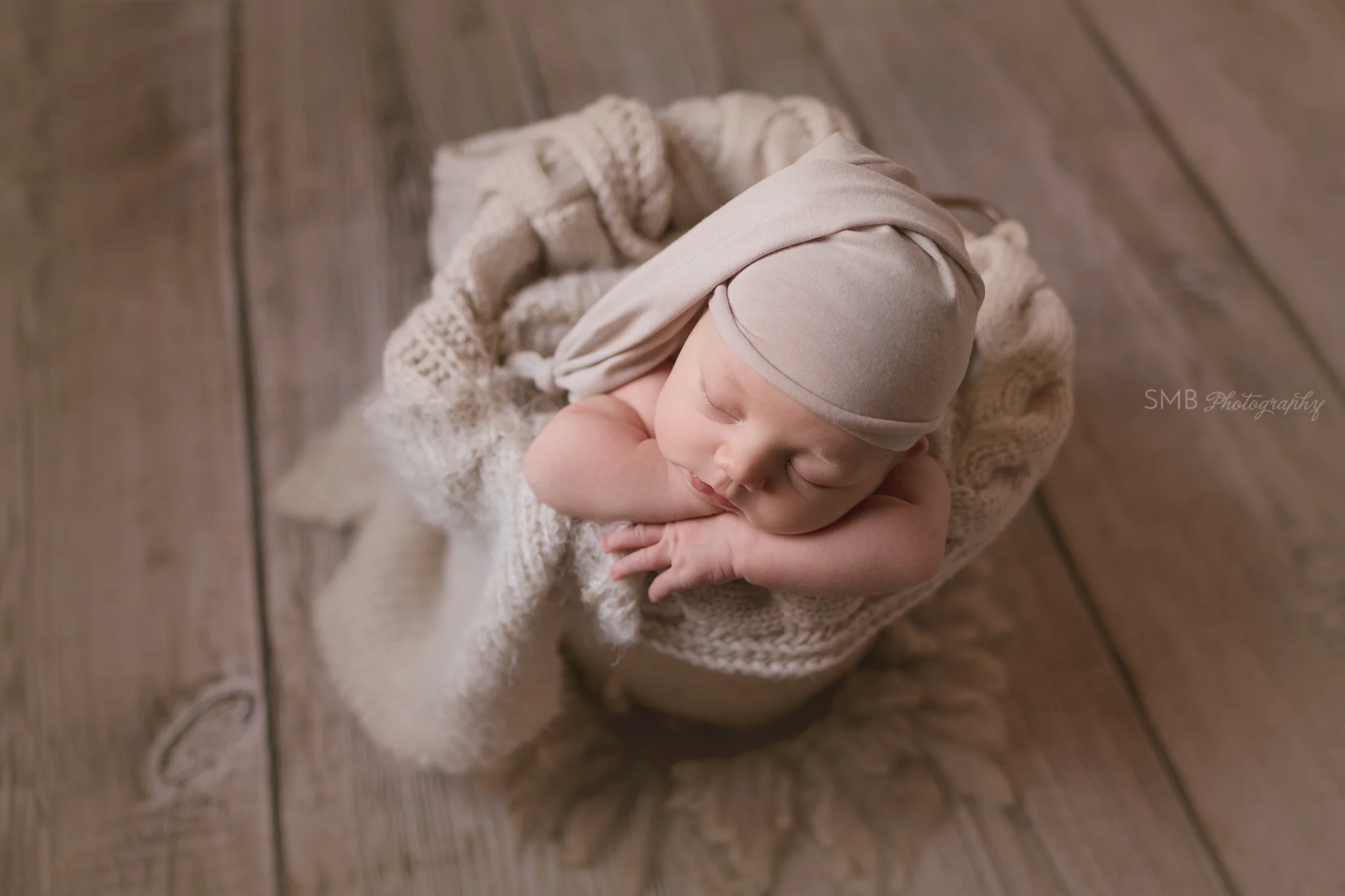 Baby boy in cream bucket