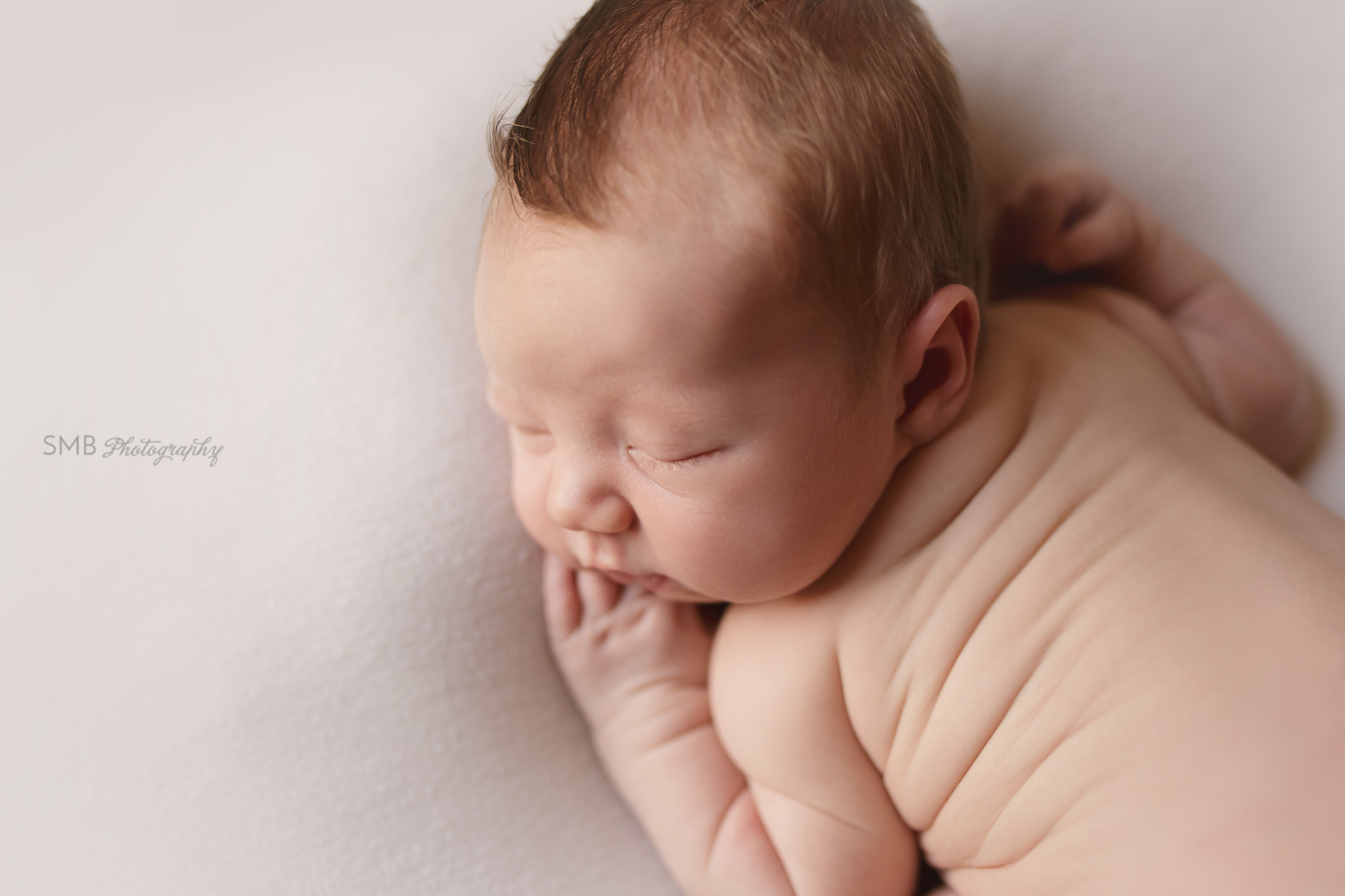 Newborn boy profile portrait