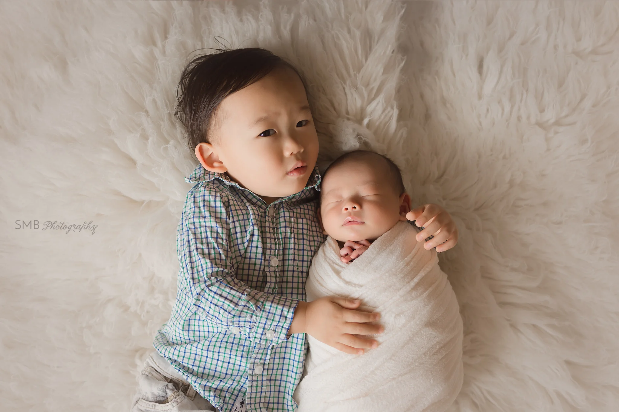 Big brother laying down with baby brother