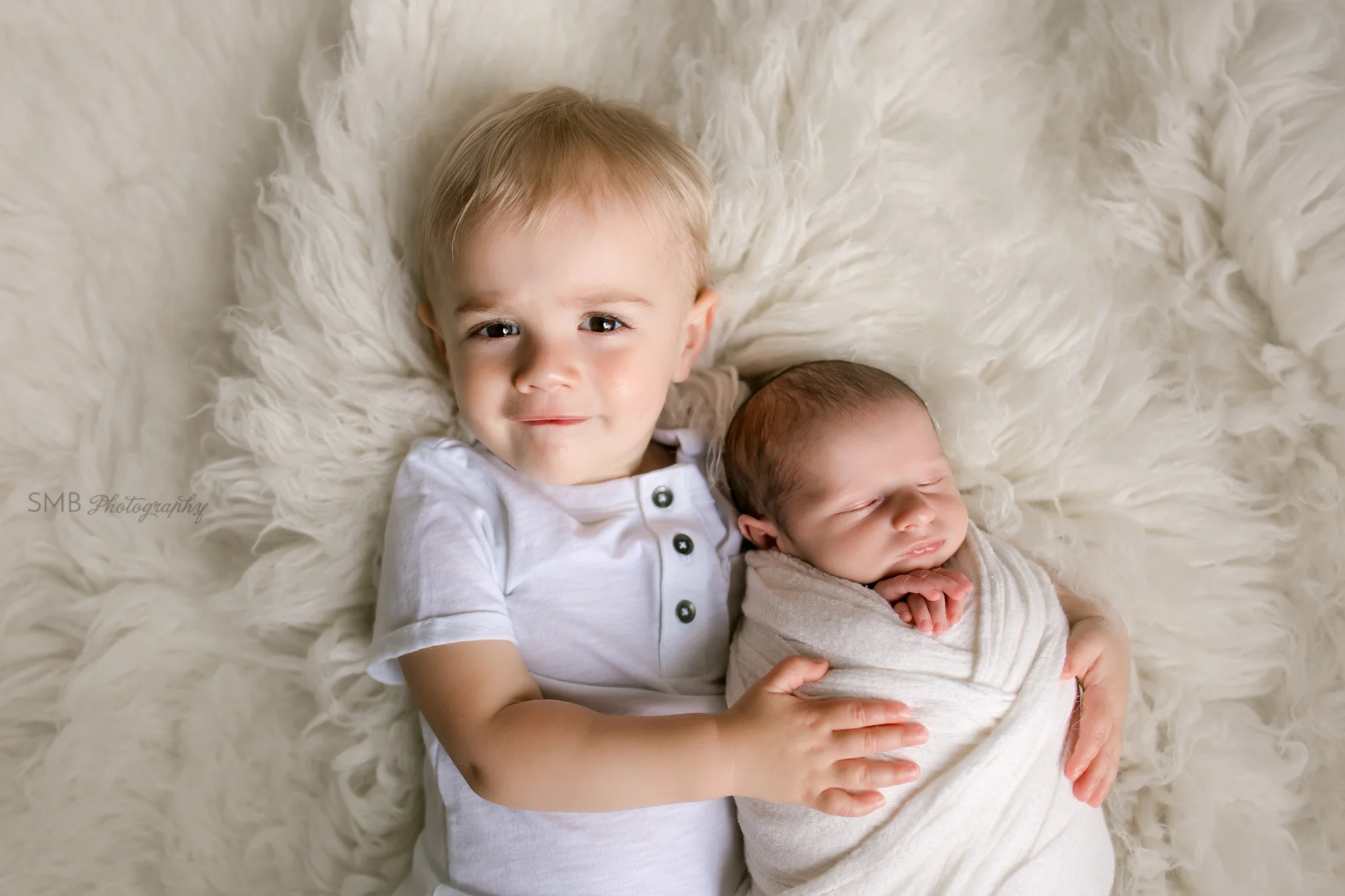 Big brother holding new baby brother