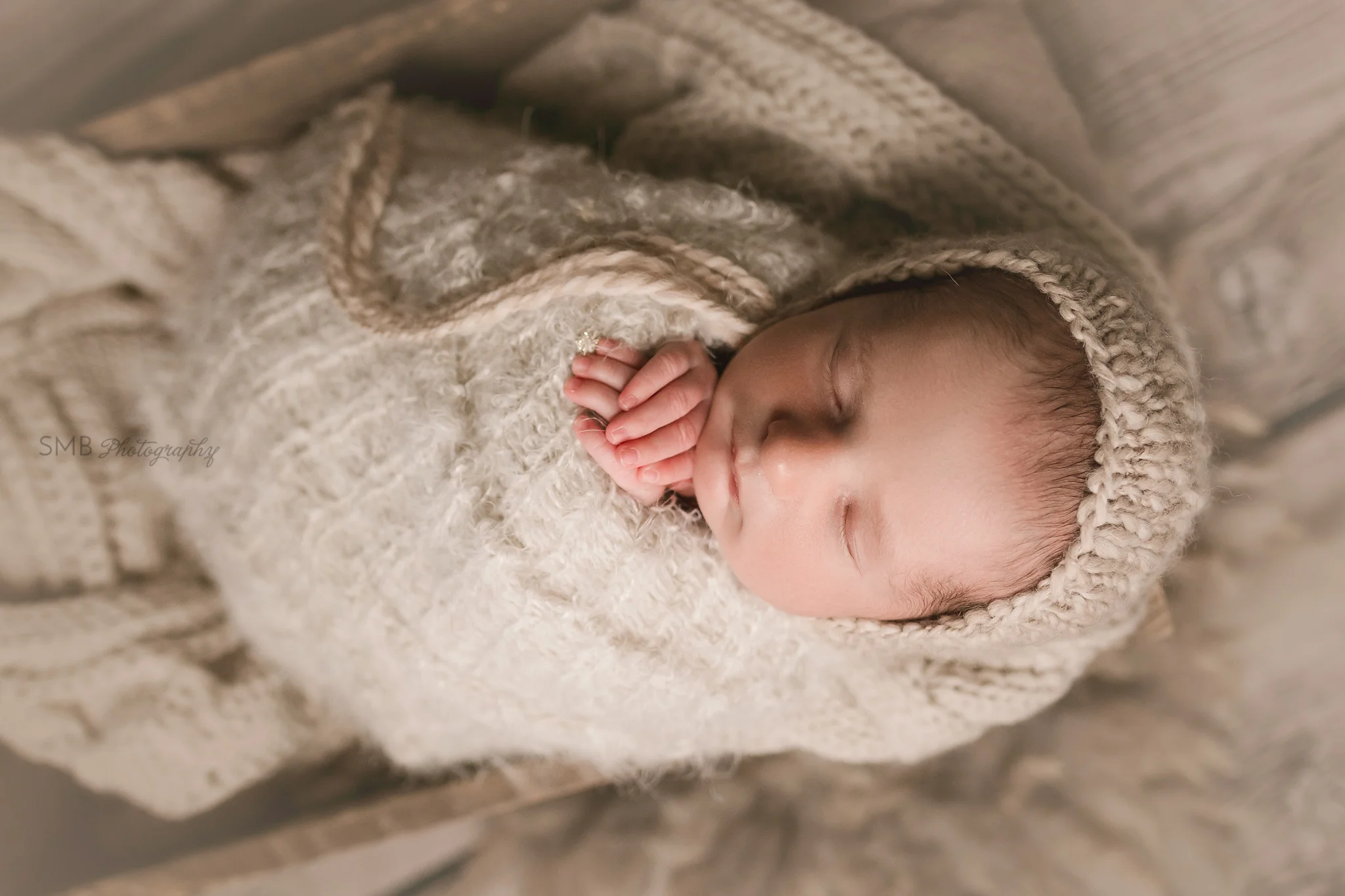 Baby boy wearing beige bonnet