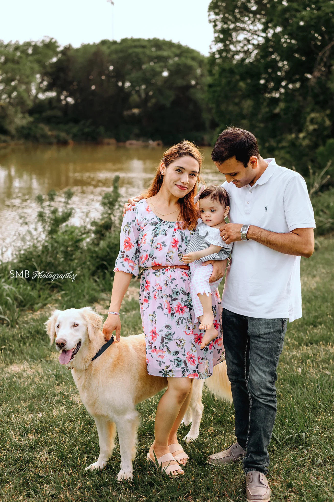 Mom, Dad, birthday girl and dog standing in front of pond at Hefner Park