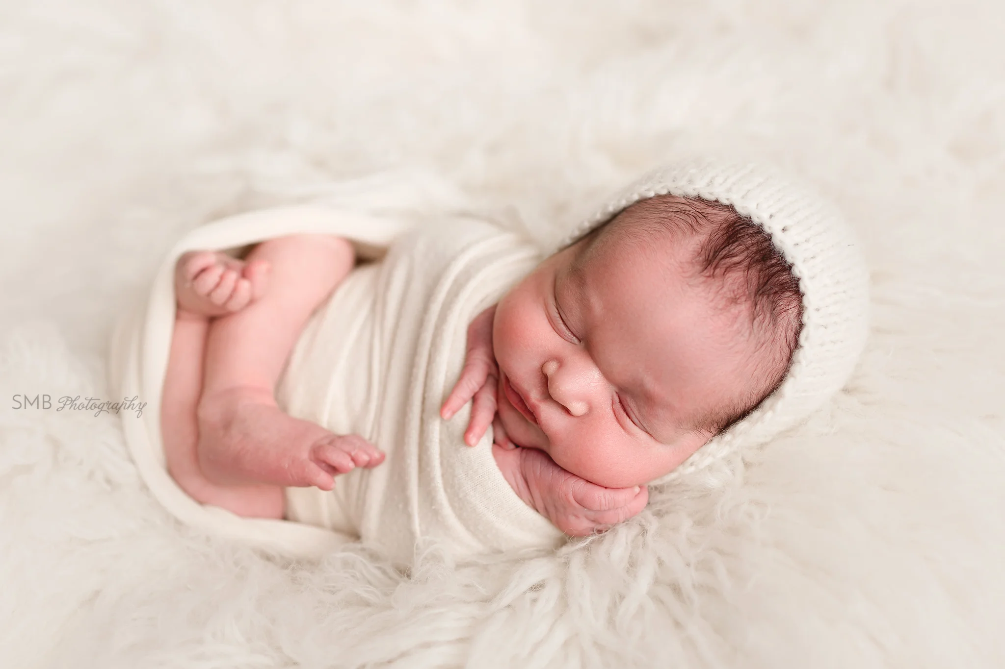 Baby wrapped on flokati