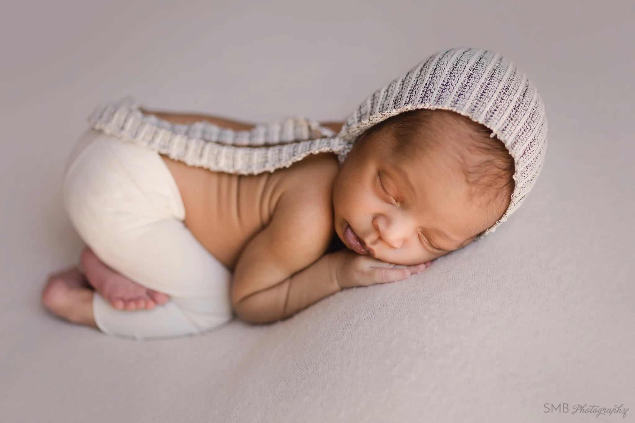 Newborn boy sleeping on tummy