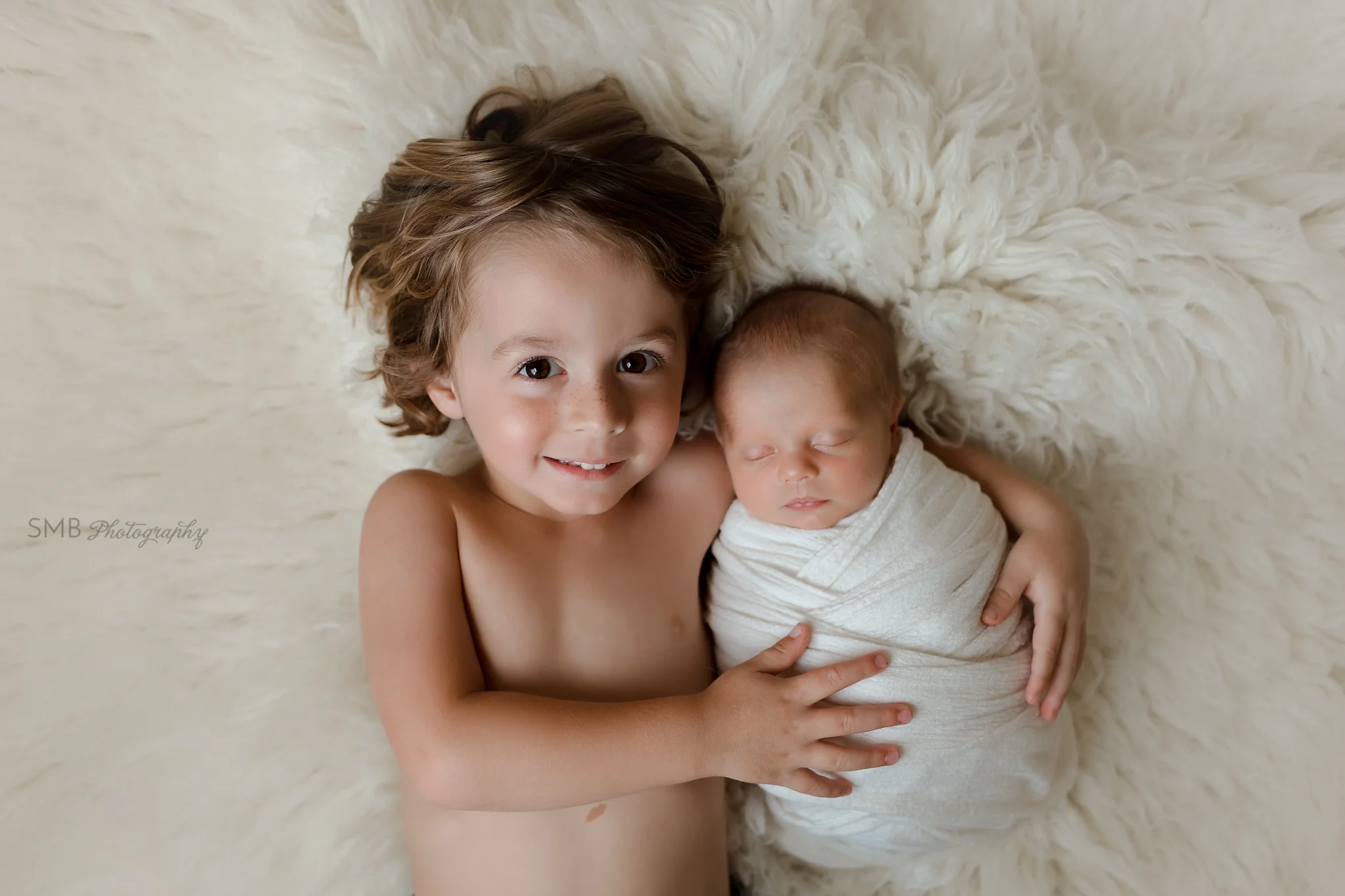 Big brother holding new baby
