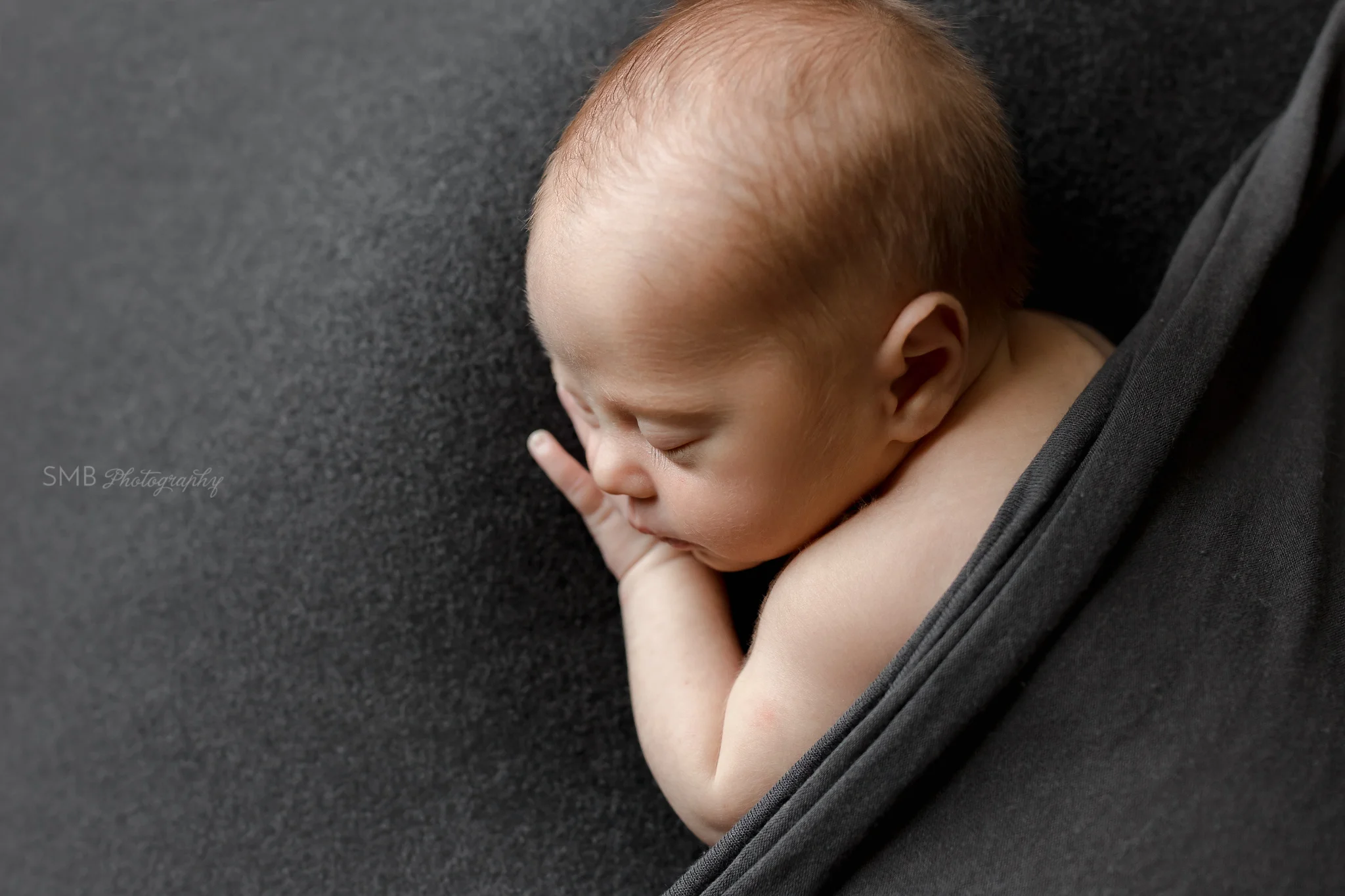 Newborn baby tucked in sleeping