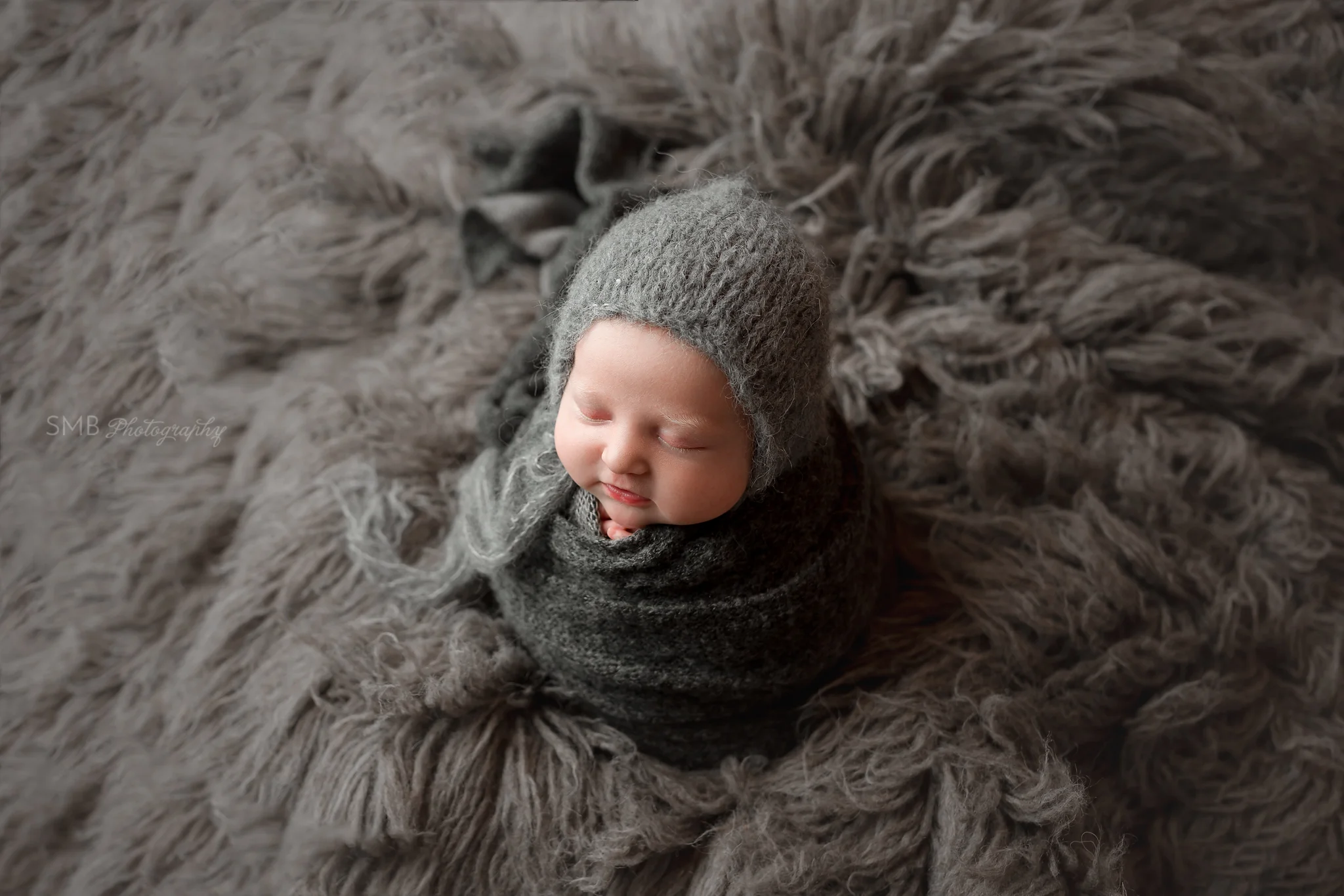 Newborn baby girl smiling