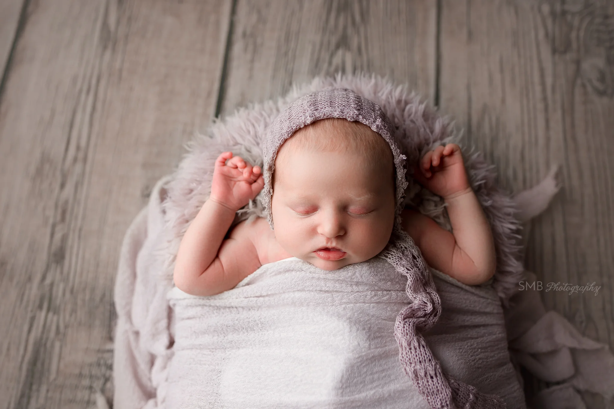 Baby girl tucked in with purple wrap