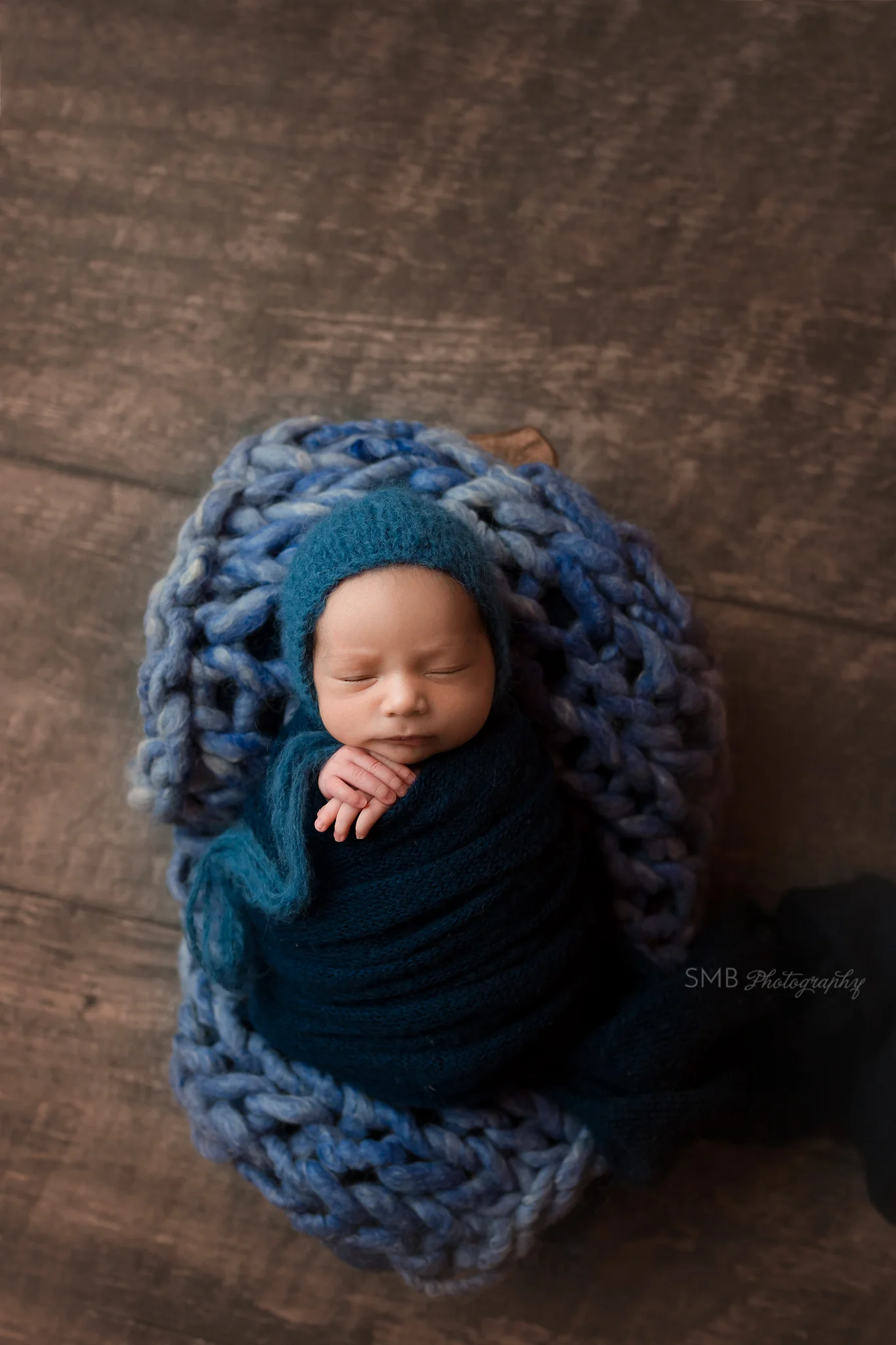 Baby boy wrapped in dark blue