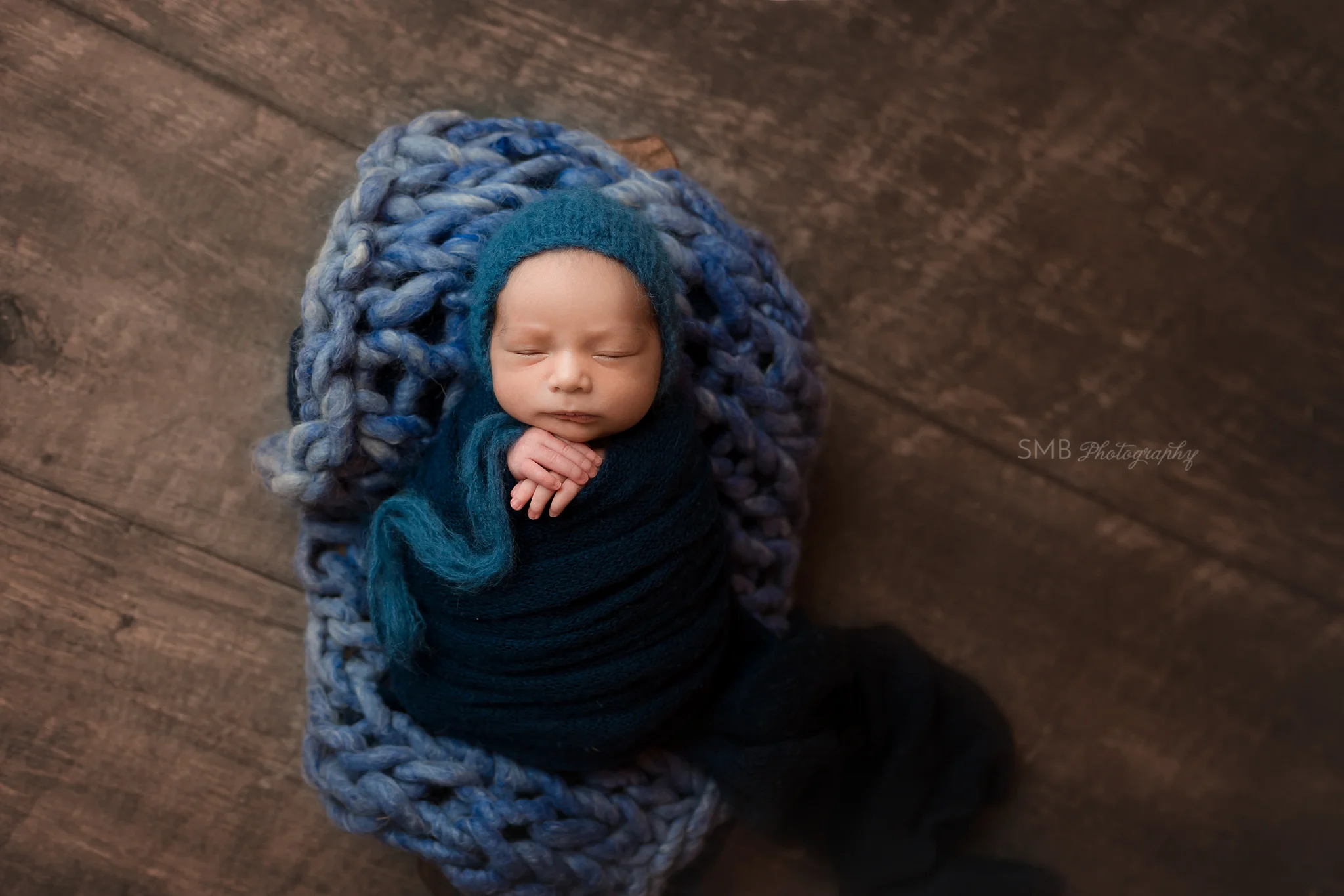 Baby boy wrapped in wood trencher
