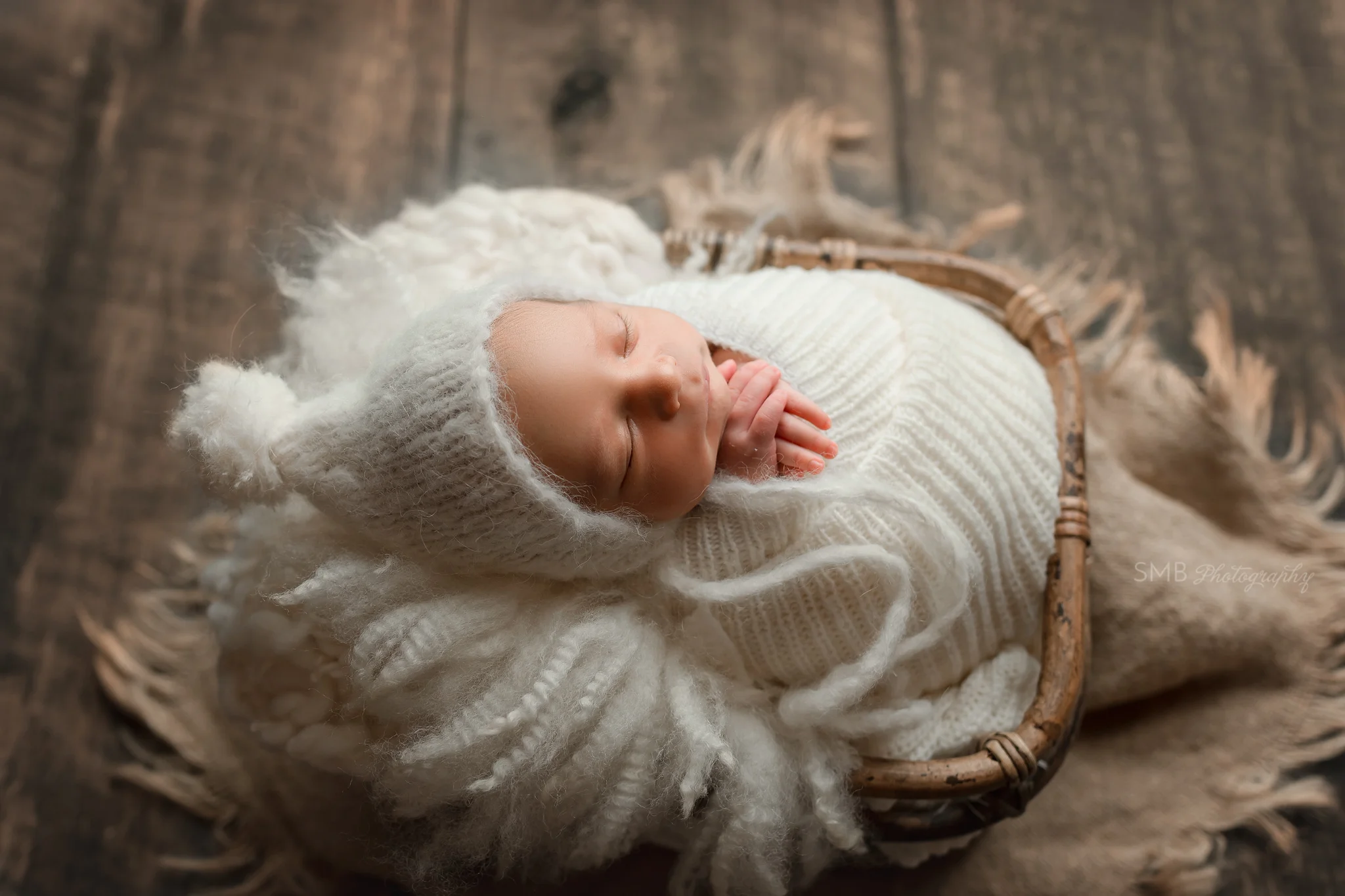 newborn wrapped in bamboo basket