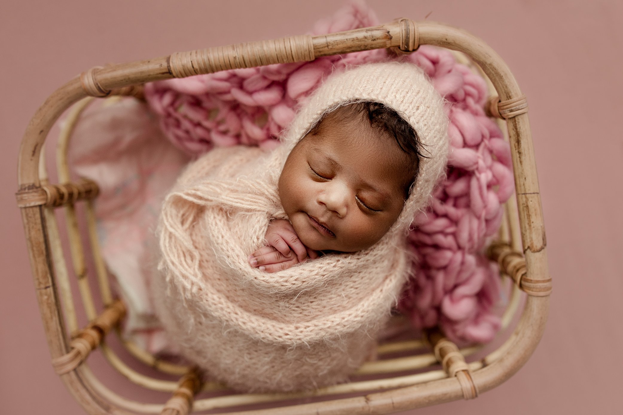 Newborn baby girl wrapped in pink