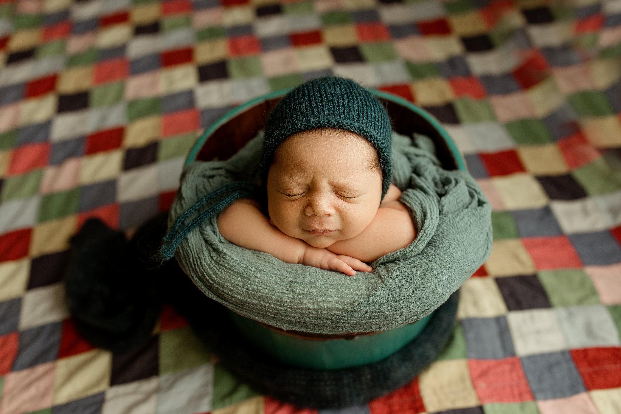 Newborn boy in a bucket