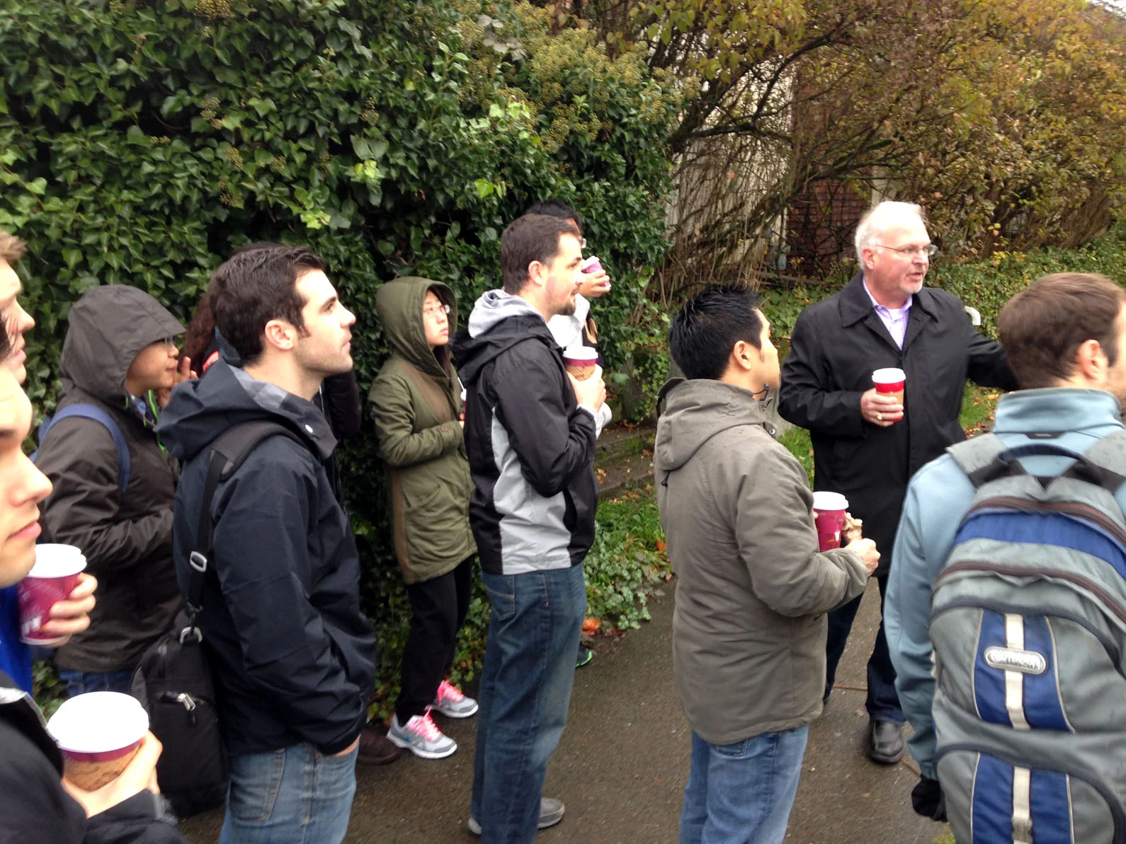 Real Estate Club members look on and ask questions as Rick explains the construction process