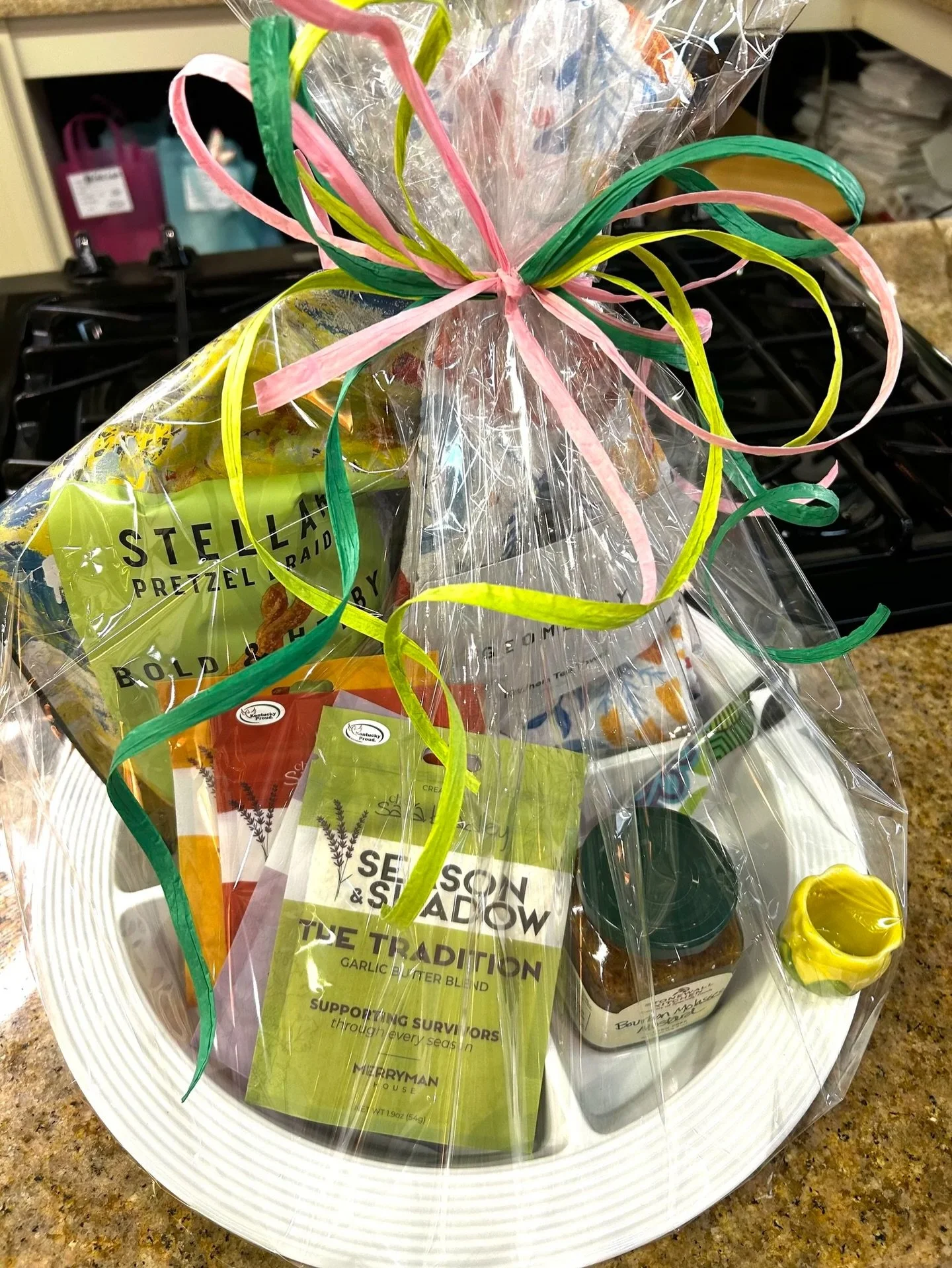 A lively combination of beauty and delicious detail. The Nora Fleming base and mini create instant presentation charm, while the Pepper Jelly and Stellar Pretzels deliver crowd-pleasing flavor. Season &amp; A Shadow adds depth, and the Geometry towel