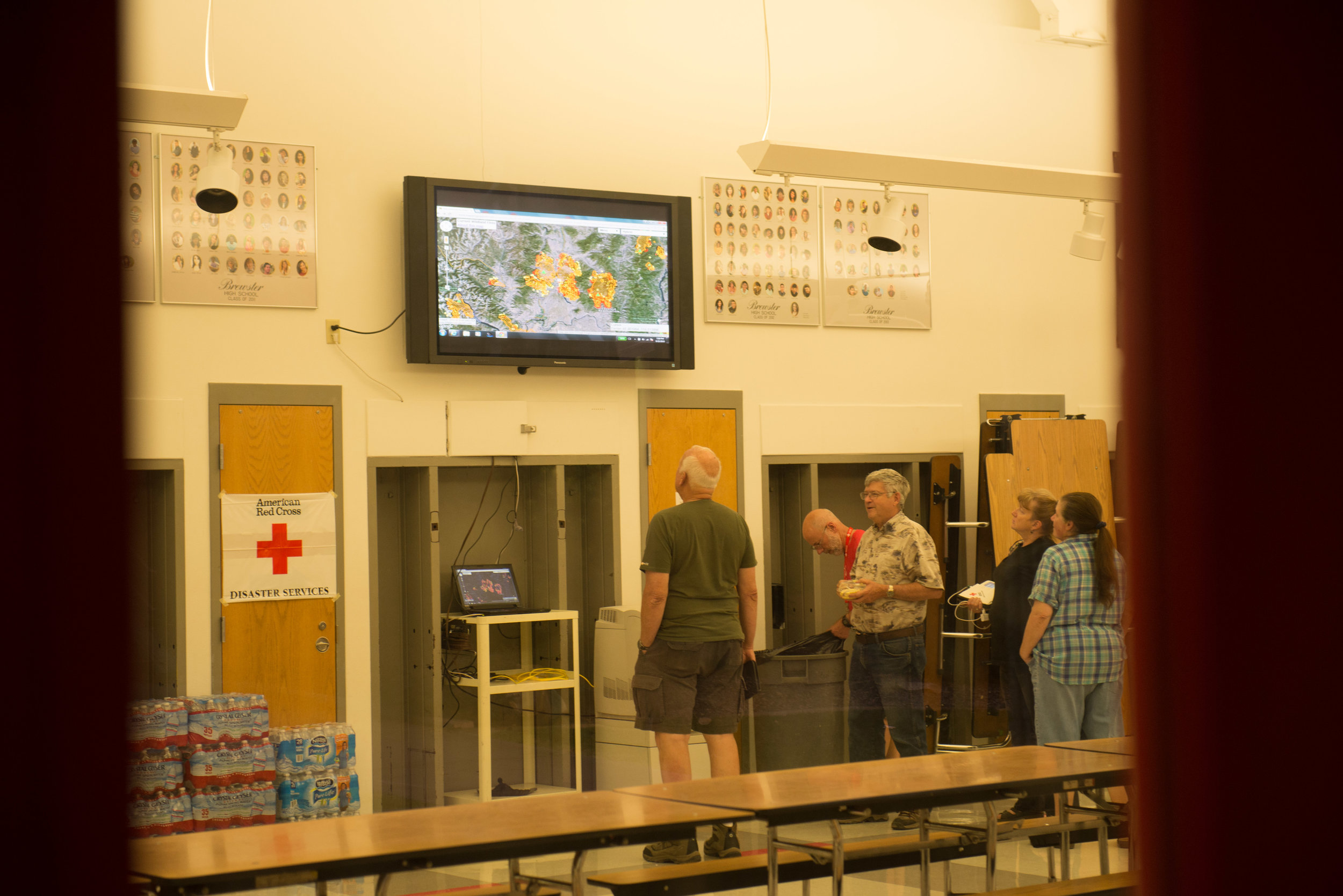  Evacuees monitor fire expansion at Red Cross Shelter Brewster High School, Brewster, WA, Saturday August 22, 2015. The Red Cross partnered with a number of schools and community centers in Okanogan County to provide food and shelter for an ever-fluc