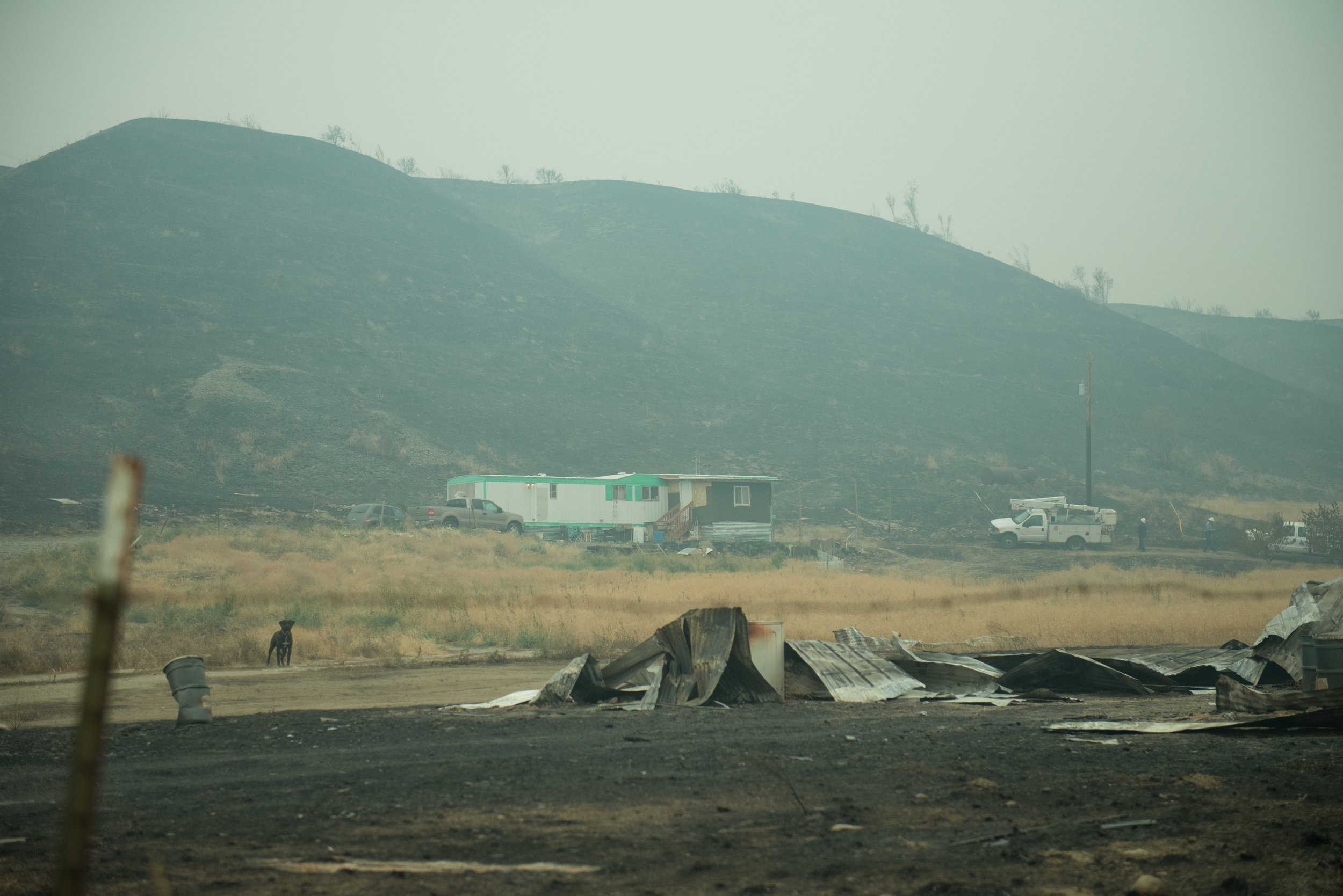  A residence stands next to the fire line in Omak, Monday August 24, 2015. 