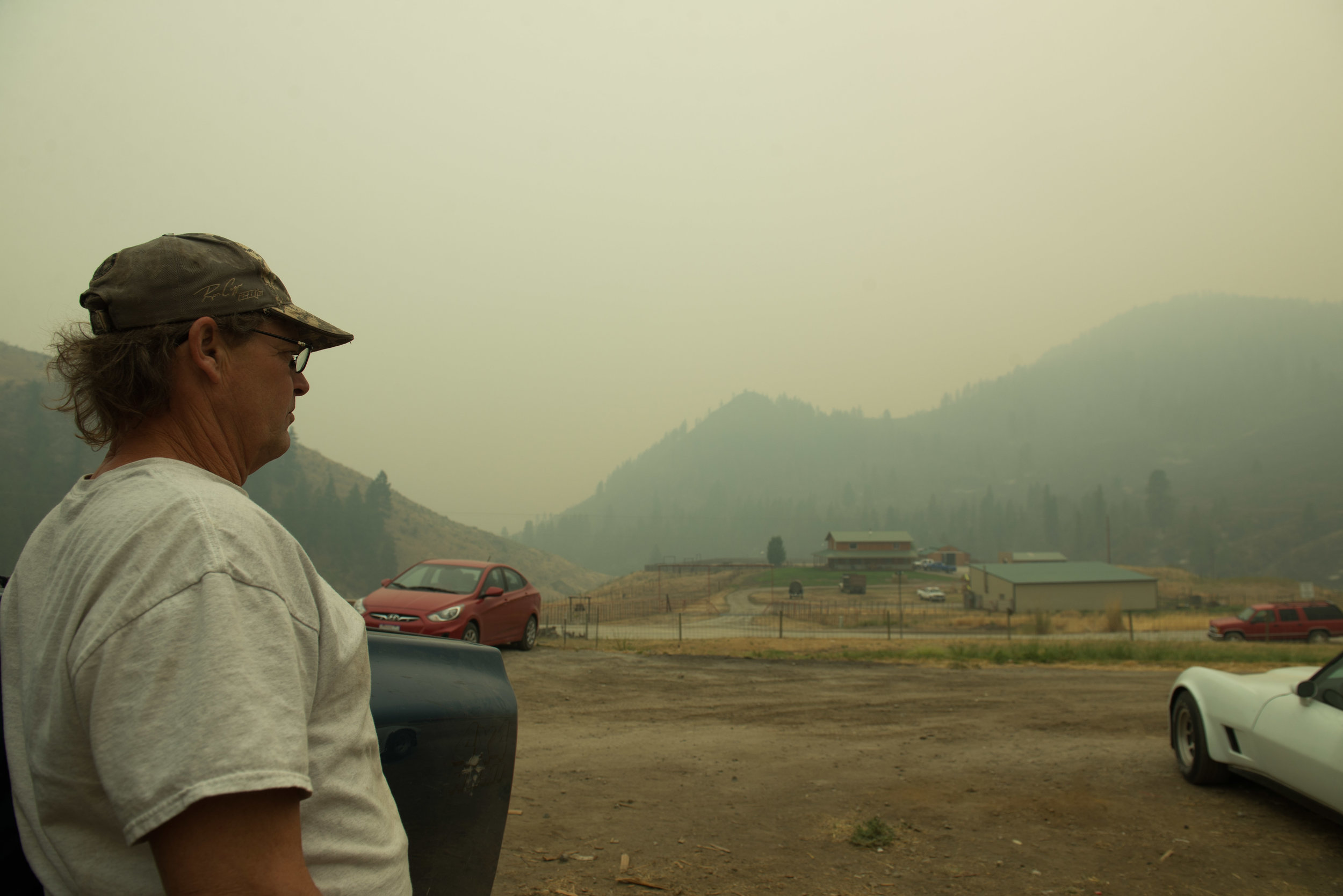  Allan Williams observes scorched hills in front of his home in central Okanogan County, Monday August 24, 2015. Two nights before, Allan assisted firefighters as they cut a fire line with a tractor and other equipment so fire would not spread to his