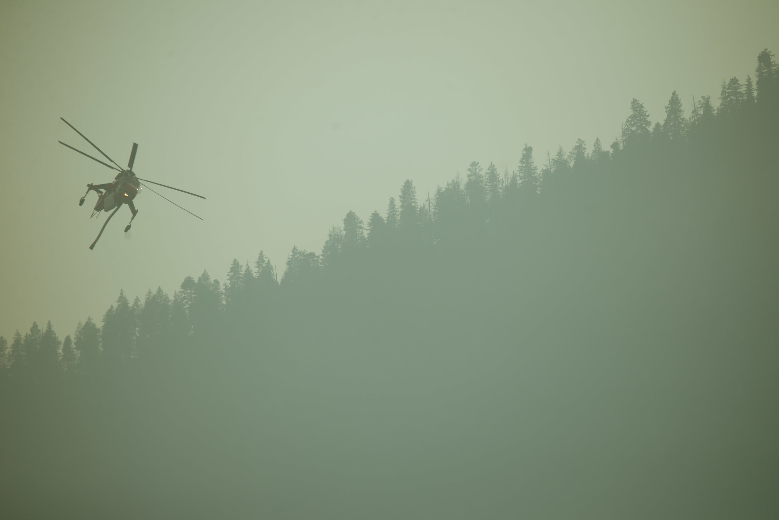  "Incredible Hulk", an Aircrane Helicopter operated by Erickson Aviation, approaches Lake Chelan near Manson, WA, to refill its water tank, Tuesday August 25, 2015. "Hulk" has been modified to hold 2,650-gallons of fresh or salt water that is refille