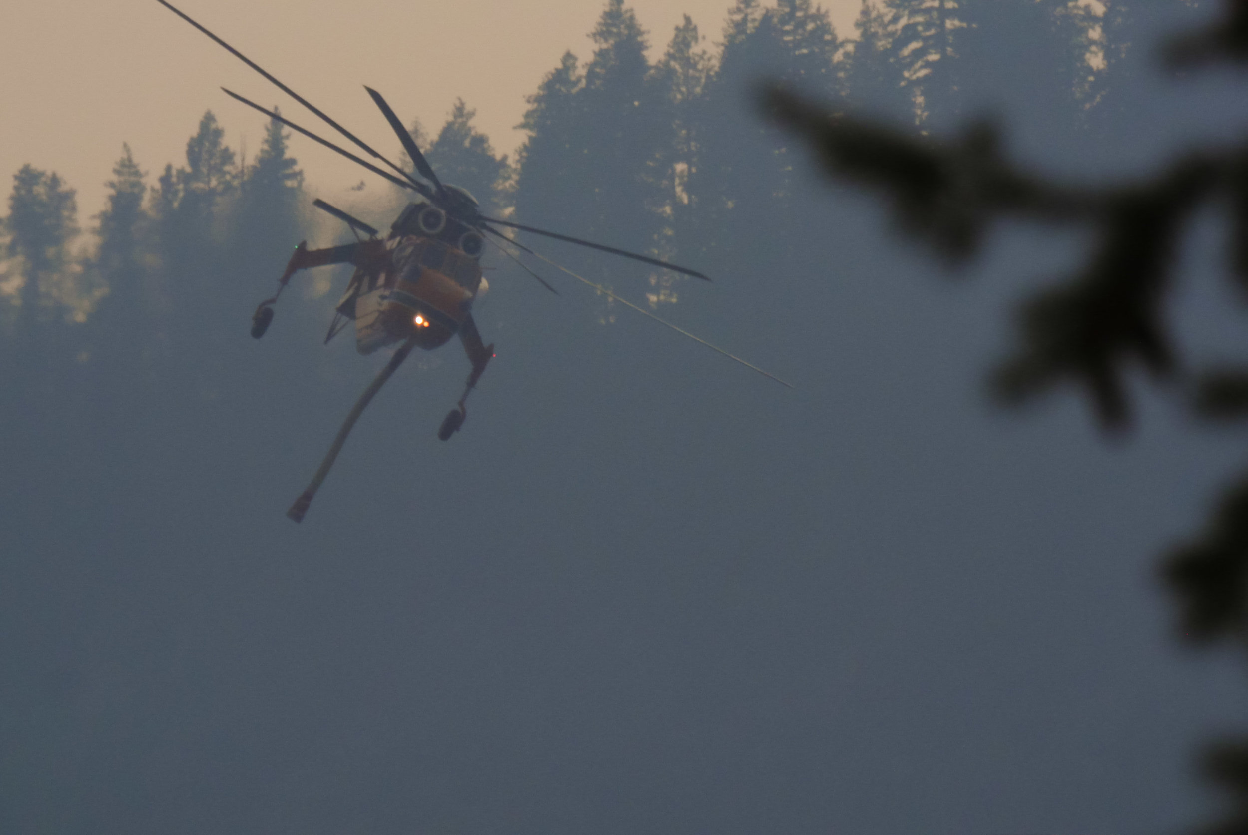  "Incredible Hulk", an Aircrane Helicopter operated by Erickson Aviation, approaches Lake Chelan near Manson, WA, to refill its water tank, Tuesday August 25, 2015. "Hulk" has been modified to hold 2,650-gallons of fresh or salt water that is refille