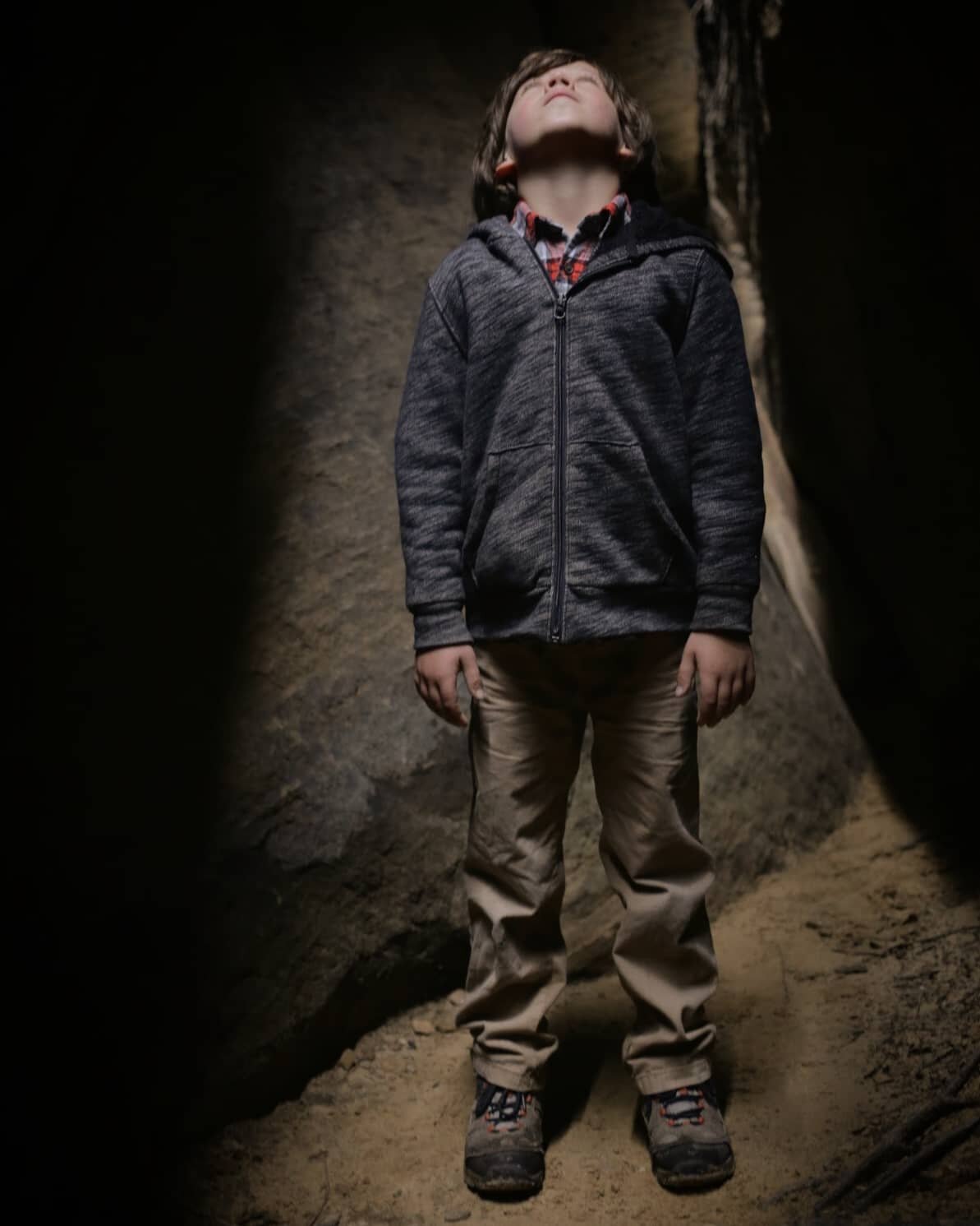 Eight-year-old CoCo looking up through the slot canyon at Cloud Splitter. #kidsbelongoutside