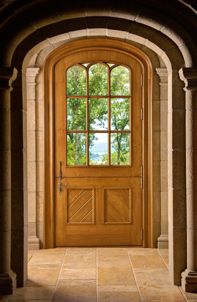  Oversized dutch door with tudor arch -&nbsp;true divided light glass design. 