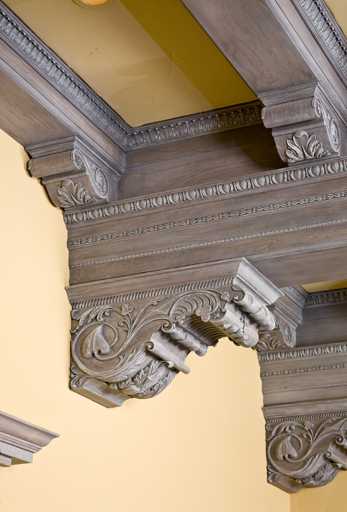 Custom handcarved corbels feature spades, hearts, clubs and diamonds motifs.