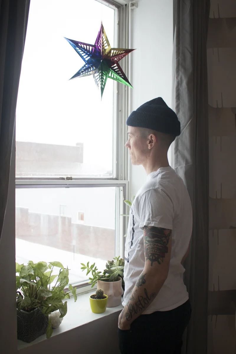 From the series, Gender is a Drag , a photo and video based work that explores and expands the space of non-binary gender. This photograph is part of a body of work comprised of videos and stills documenting the transformations I undergo due to taking hormones. There are also videos in which I discuss various topics related to gender in general, gender theory, my own experience and concepts that I am researching in conjunction with this work. Being white, able-bodied and often viewed as masculine, allows me to remain relatively safe as a non-binary person. I am in a position where I can use my privilege to make more space for non-binary and gender non-conforming people. With the increasingly popularized use of “they” as a non-binary gendered singular pronoun, people are becoming aware that not everyone fits neatly under the pronoun she or he. Rather than being excited by the possibility of new ways of being, when met with expansive forms of self-expression (i.e. people who are gender non-conforming and/or non-binary, and/or non-binary trans) most people are frightened and / or enraged by the existence of people who present identities that have not been authorized by dominant culture. We see this regularly in with the rights for trans bathroom bills, with the murder of gender non-conforming people and violence and hate crimes perpetrated against non-binary people.