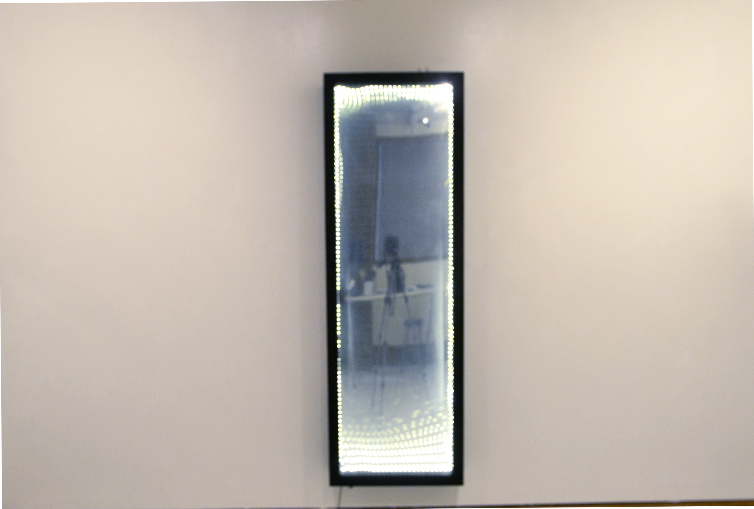  Infinity Mirror. Plexiglass, mirror panel, LED string-lights, wooden frame. 16x62.&nbsp; 