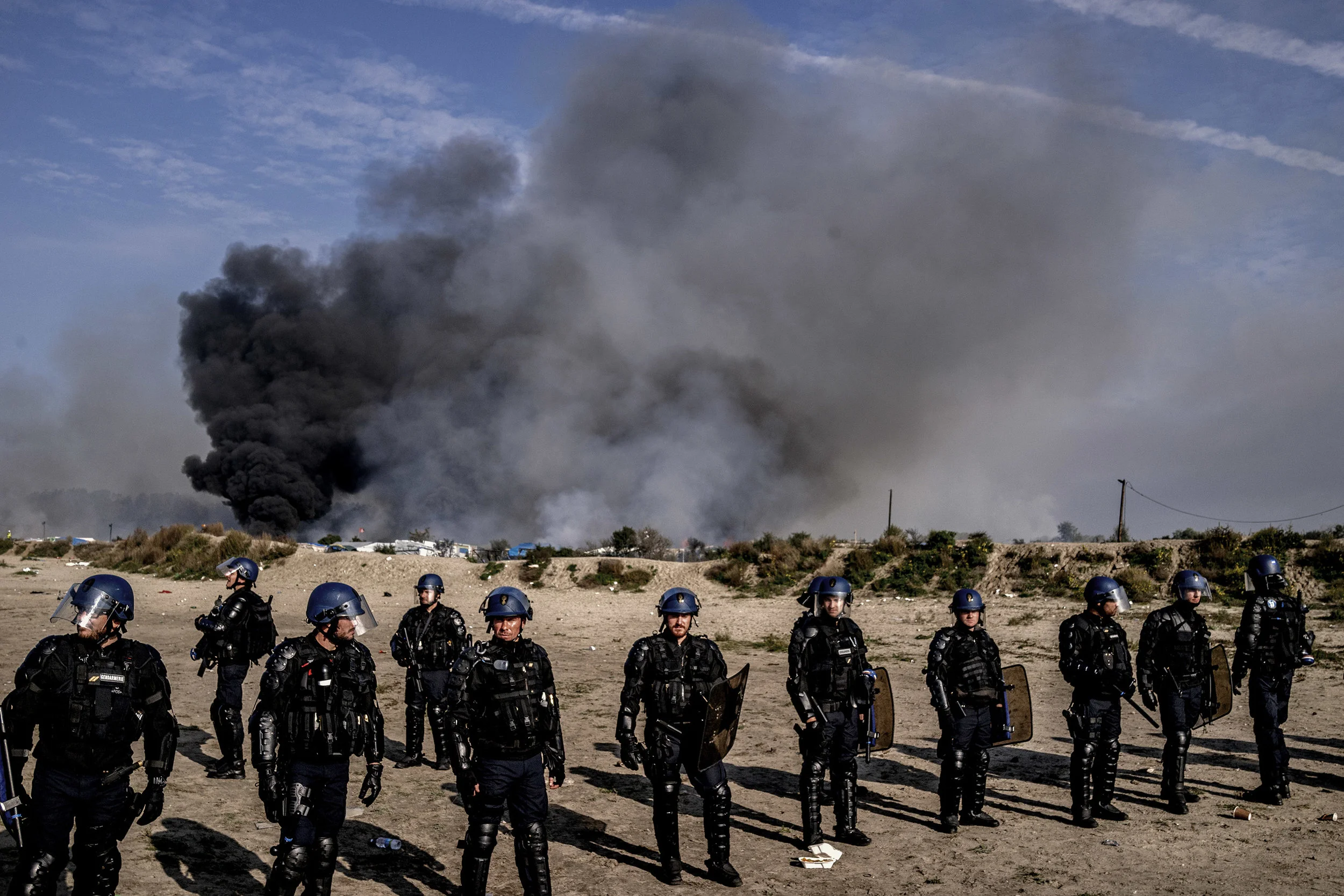 26th October 2016, The Jungle of Calais in France is in huge fire. French police cordon the entrance of the jungle of calais.
