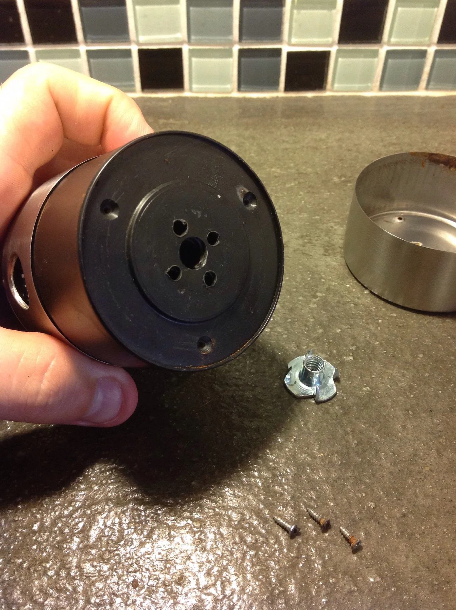 Buy a 1/4-20 T-nut from your local hardware store. This is the same thread as a standard tripod base. Line up the T-nut with the center of the timer. Drill a large hole in the center of the plastic timer body, then drill four smaller holes around it that will line up with the spikes on the T-nut. 