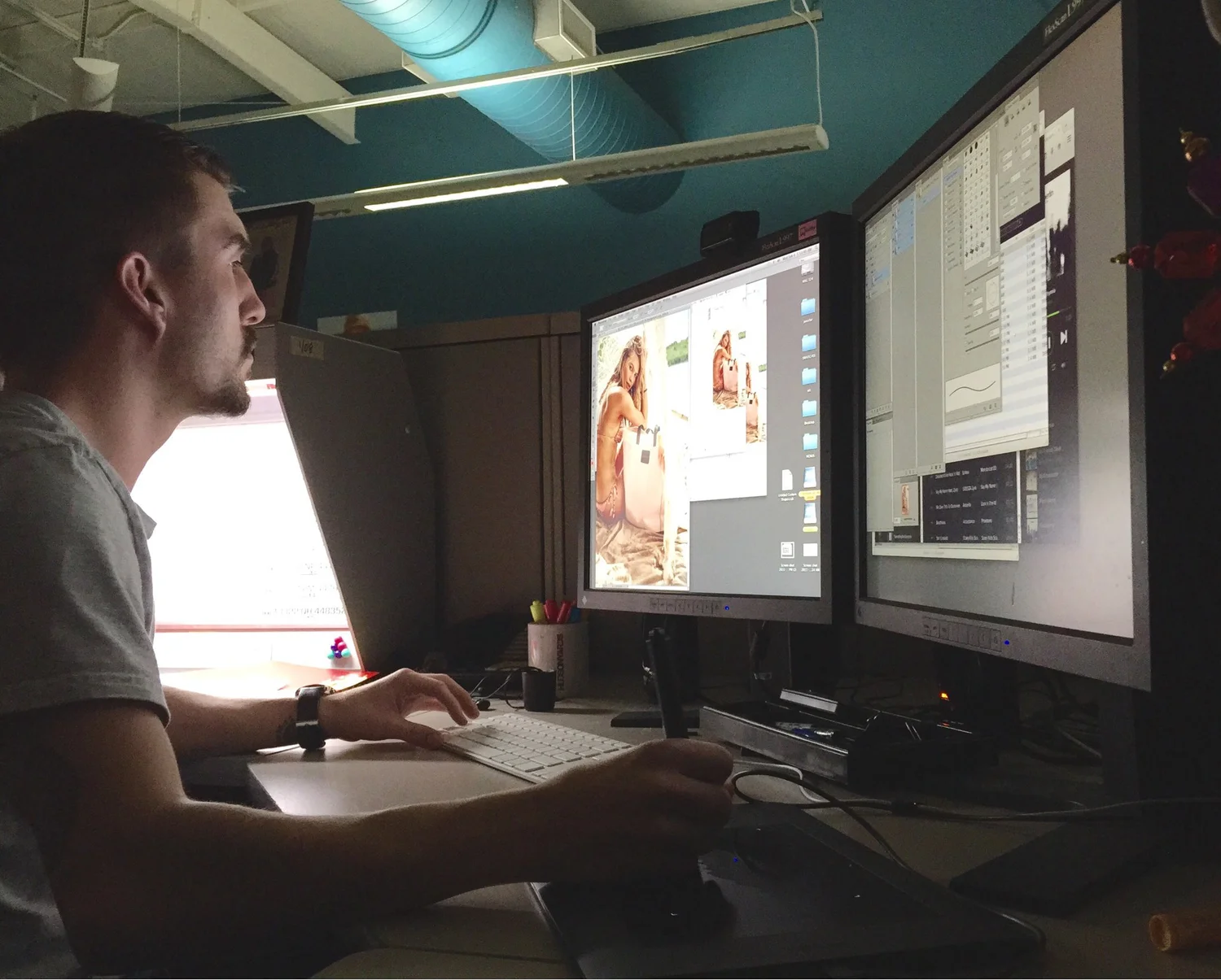 Adam Stagner editing photographs at a professional digital imaging workstation
