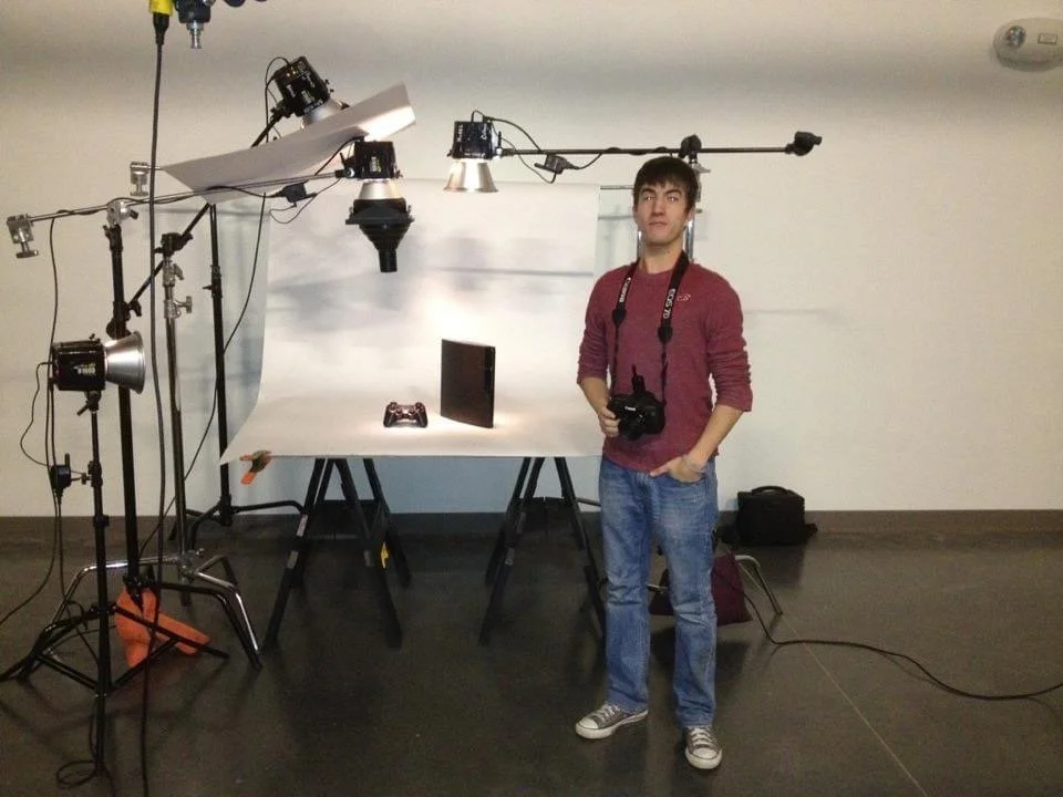 Adam Stagner with a camera beside a detailed studio lighting setup