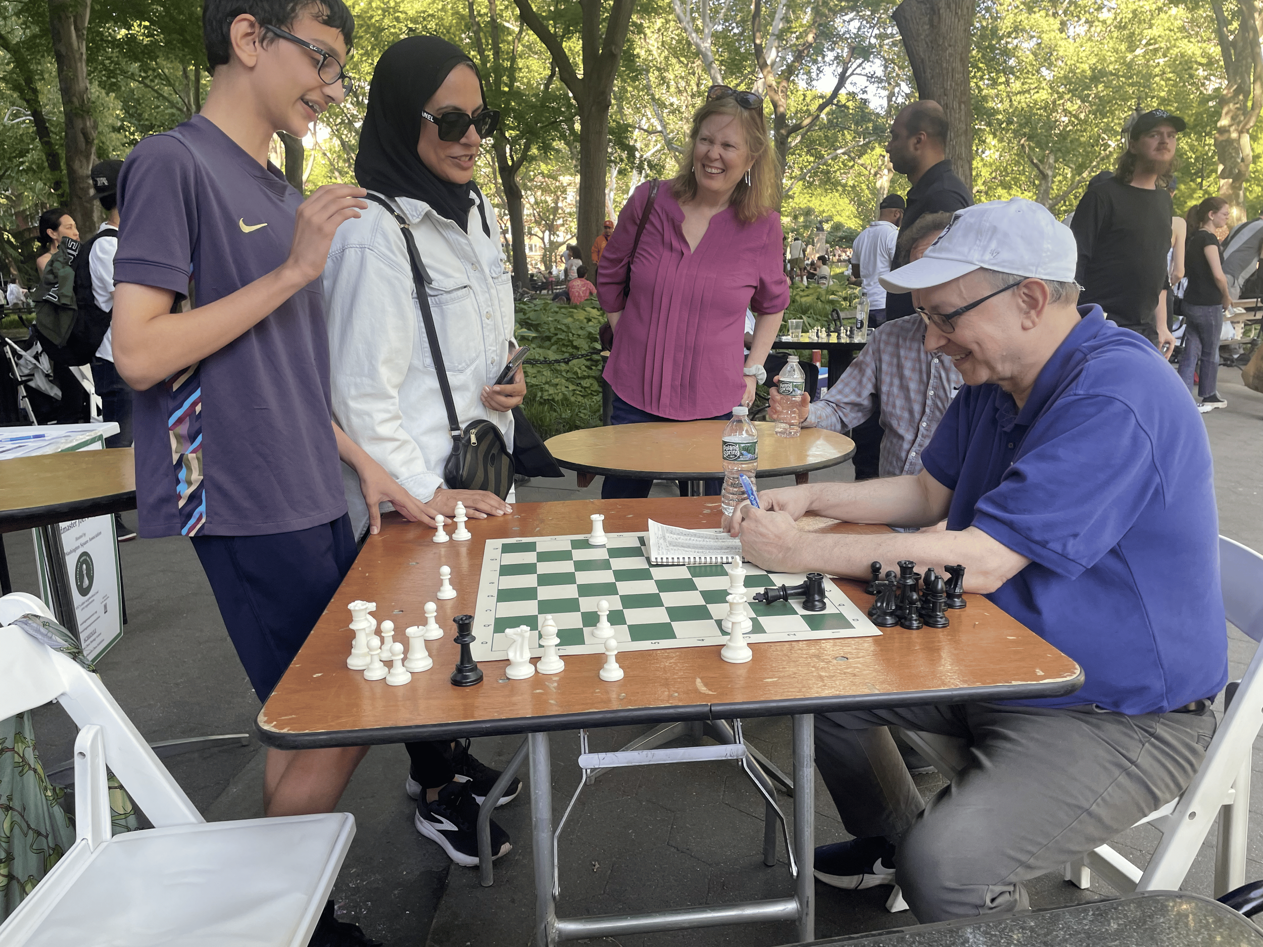 Salah Bouillon and mom Asima Bouillon with Grandmaster Benjamin after the final game of the Washington Square Association Chess Exhibition
