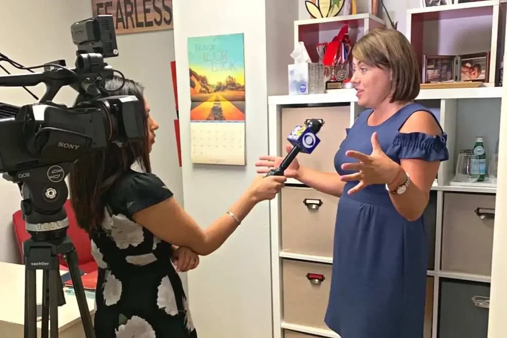 Irina Popa-Erwin providing high-performance leadership commentary during a CBS New York segment