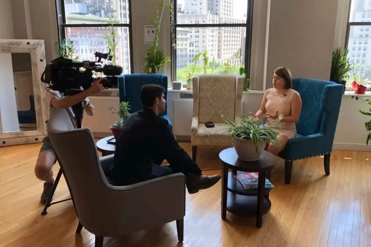 Irina Popa-Erwin, The NYC Life Coach, being interviewed on-location by CBS New York's Marc Liverman about high-performance leadership.