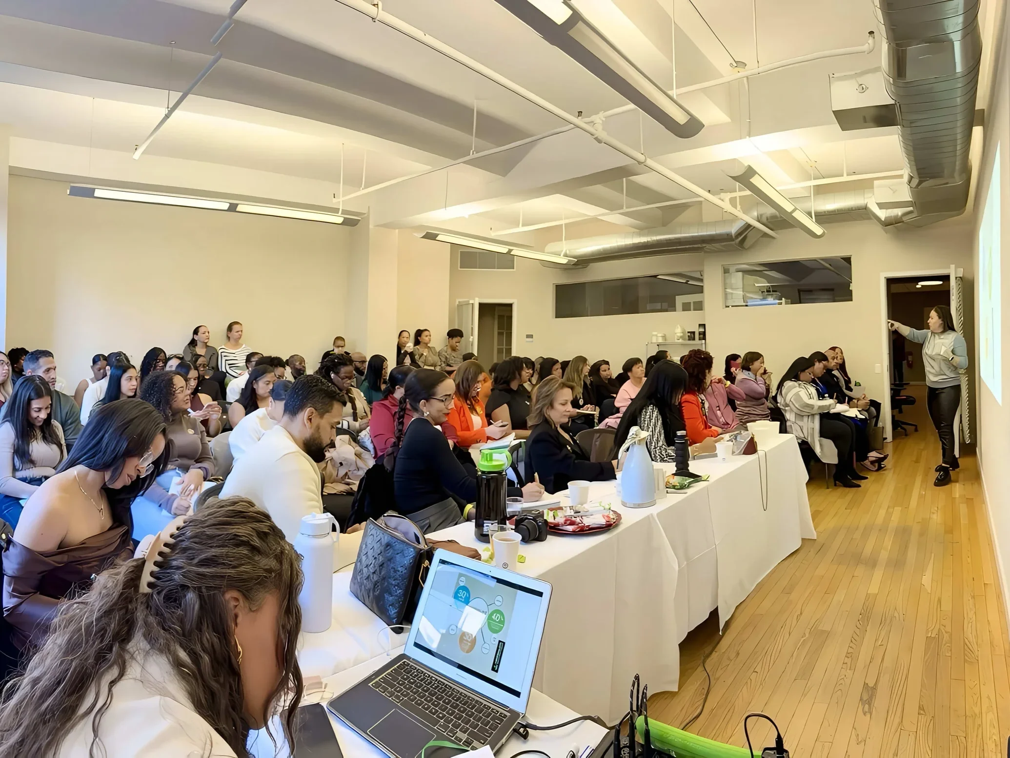 Irina Popa-Erwin, life and executive coach NYC, delivering a keynote presentation to professionals during a leadership workshop in New York City.