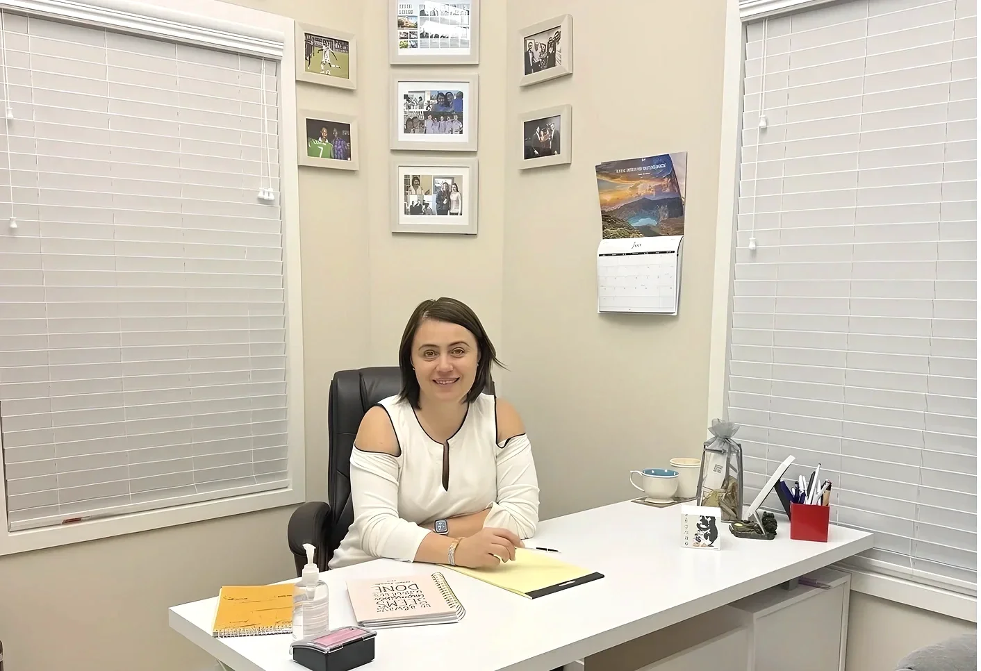 Irina Popa-Erwin, a dedicated life coach, career coach, and executive coach in NYC, at her professional Manhattan office desk preparing for a client strategy session.