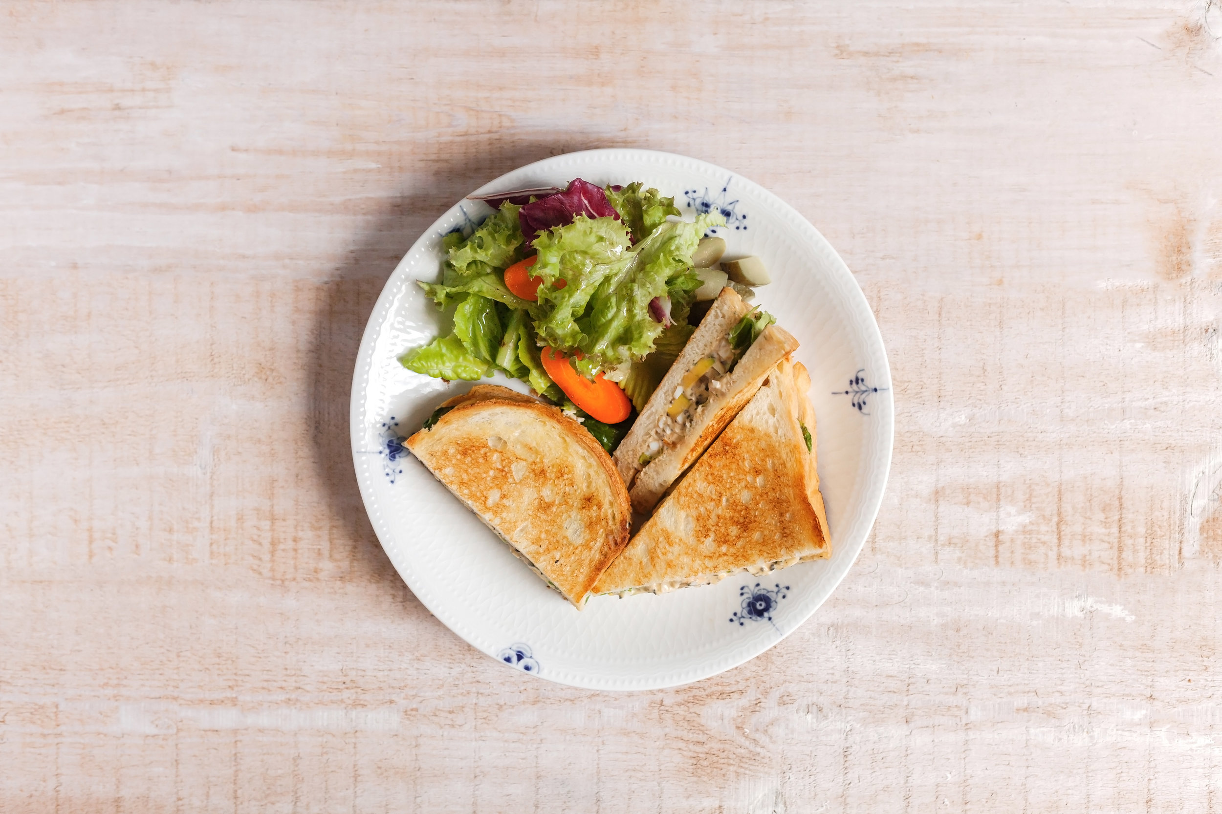 【松露拌蛋沙拉三明治】 (Truffle Egg Salad Sandwich) 優質的水煮蛋拌入美乃滋與松露蘑菇醬成了好吃的松露拌蛋沙拉,夾入烘得金黃香酥的脆皮吐司,搭配新鮮生菜一同盛盤,吃一口,松露獨特的風味與菇菇馥郁的香氣纏繞味蕾,味道美得剛剛好的三明治,滿足的完食後,接下來的一整天都會有好心情。