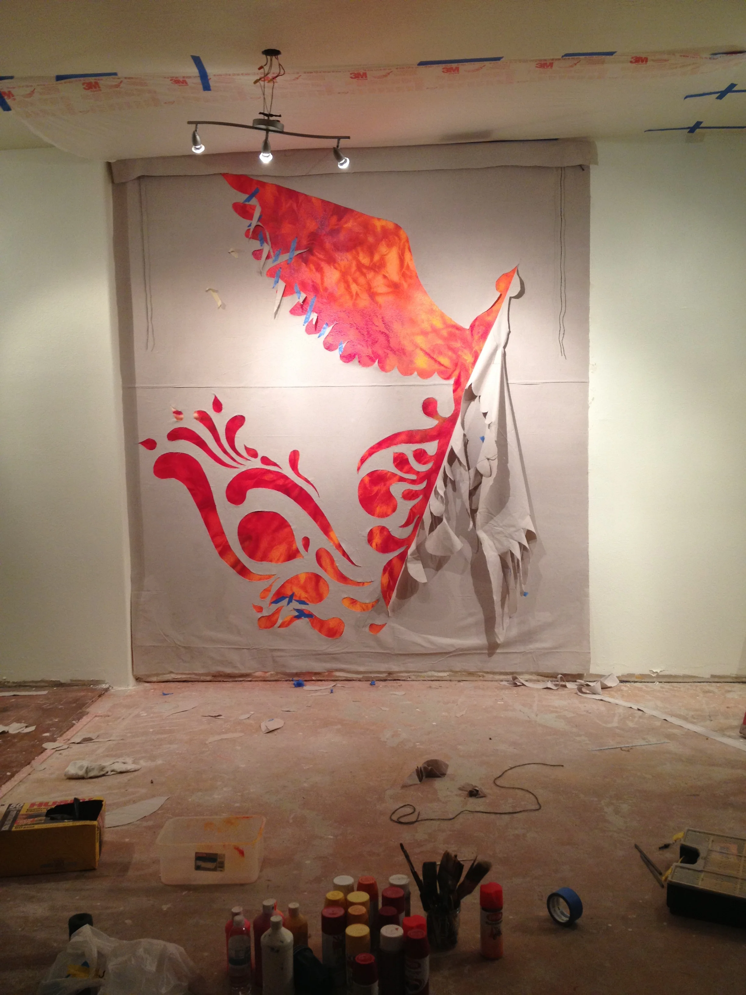 Half a bird is emerging, from behind the wall's top layer.